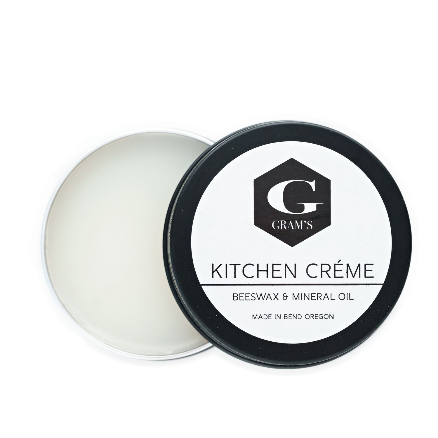 Open jar of Gram's Kitchen Creme showing white beeswax and mineral oil blend.