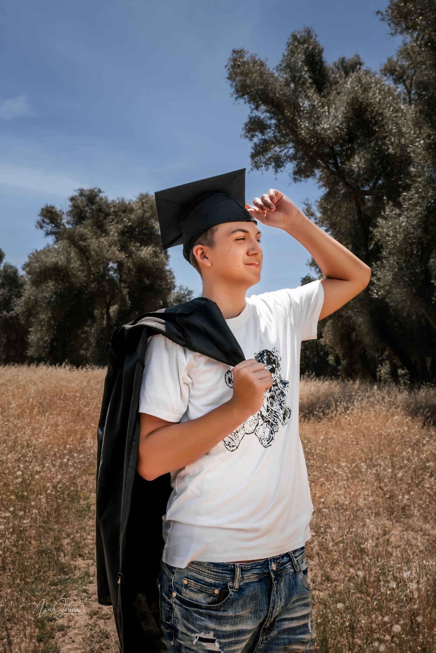 An artistic portrait series in a field showing dramatic poses against a natural backdrop.