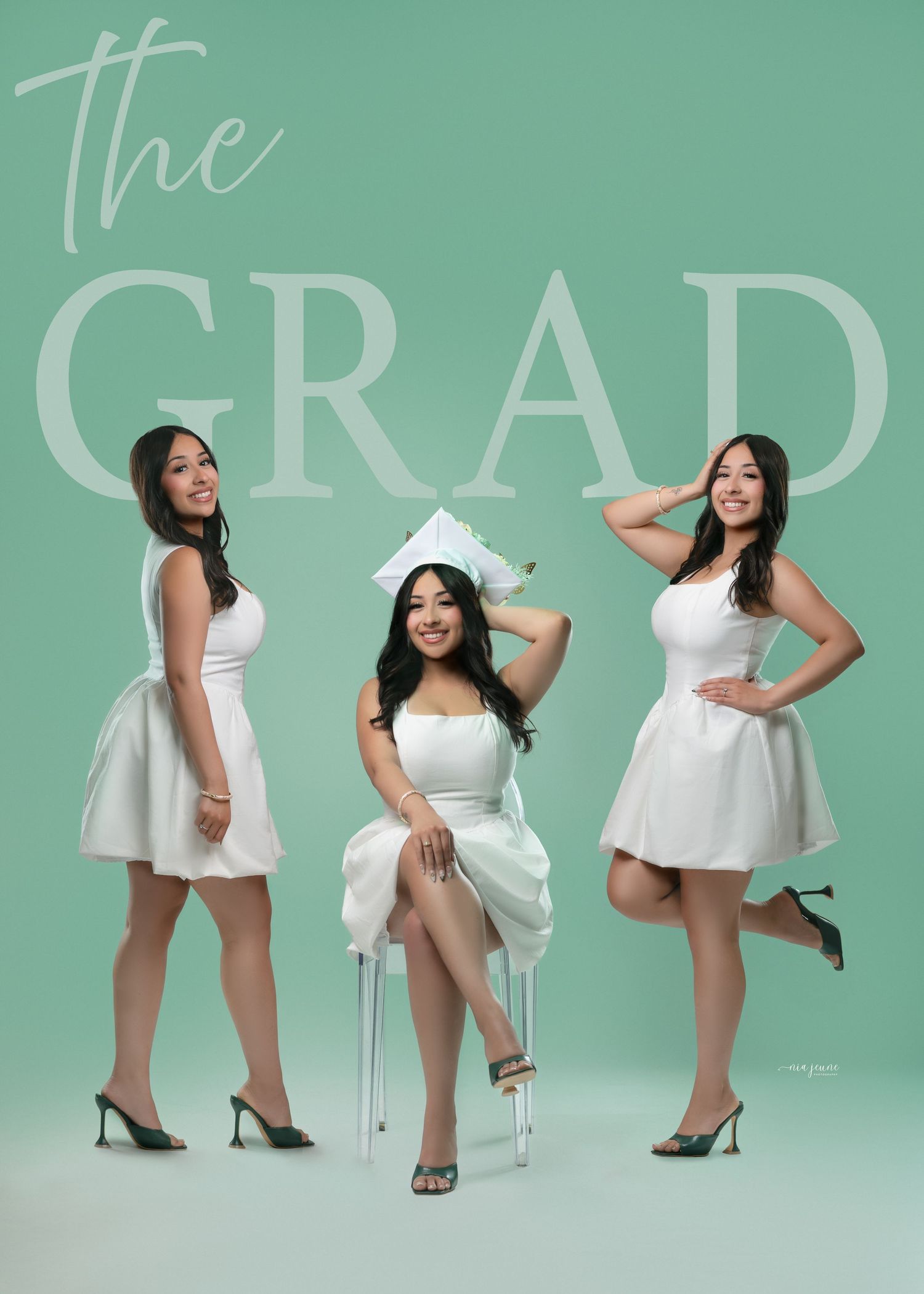 Three graduates in white dresses pose elegantly against mint green background.