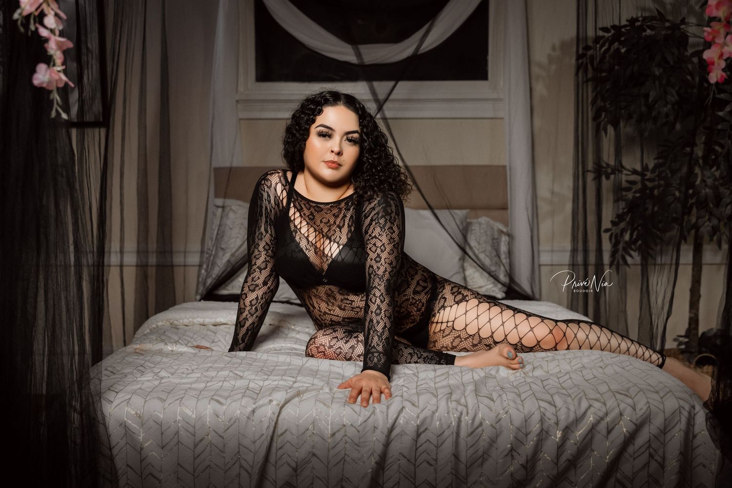 Intimate bedroom portrait with lace outfit on gray bedding.
