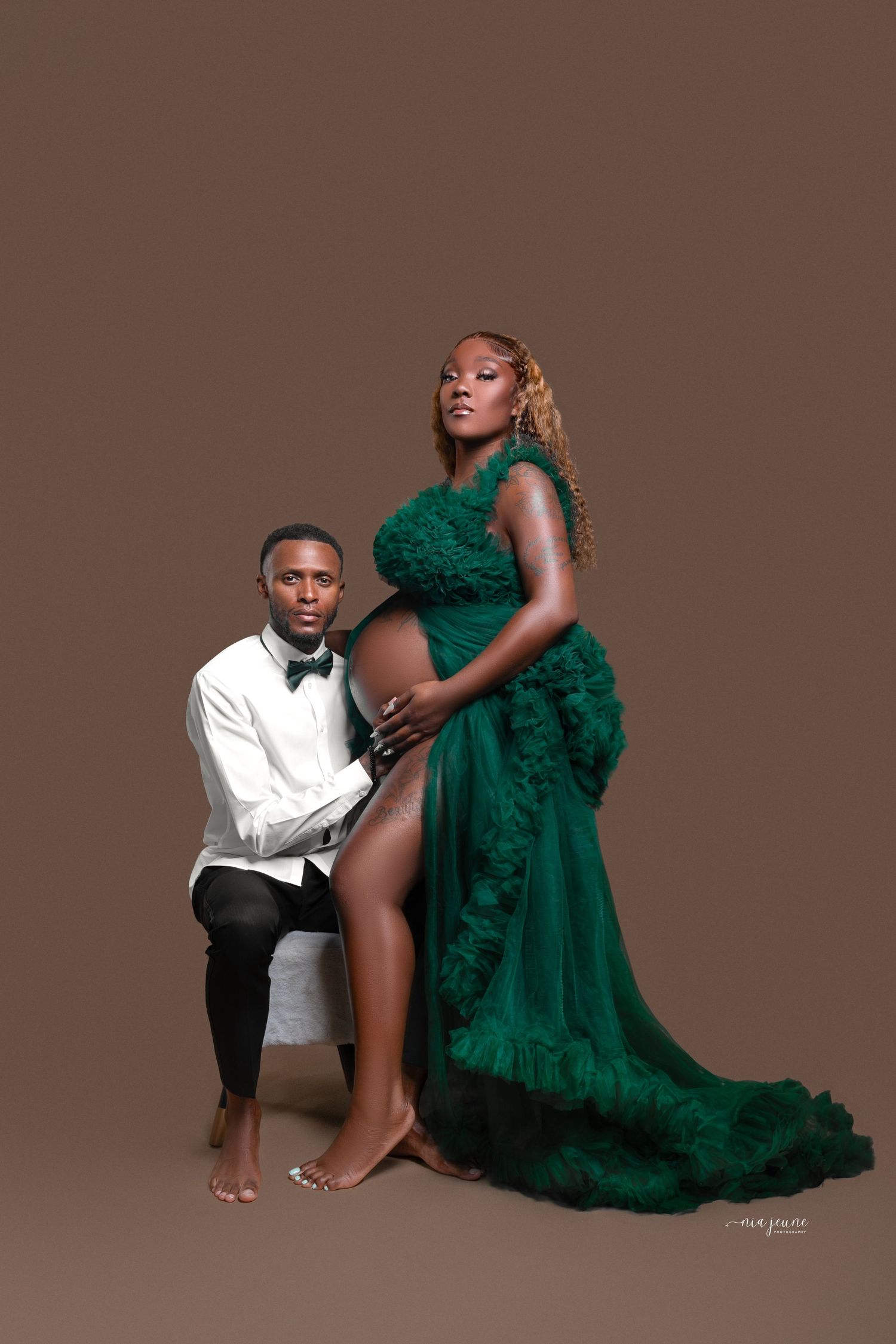 Elegant couple's portrait session featuring emerald green gown and formal attire.