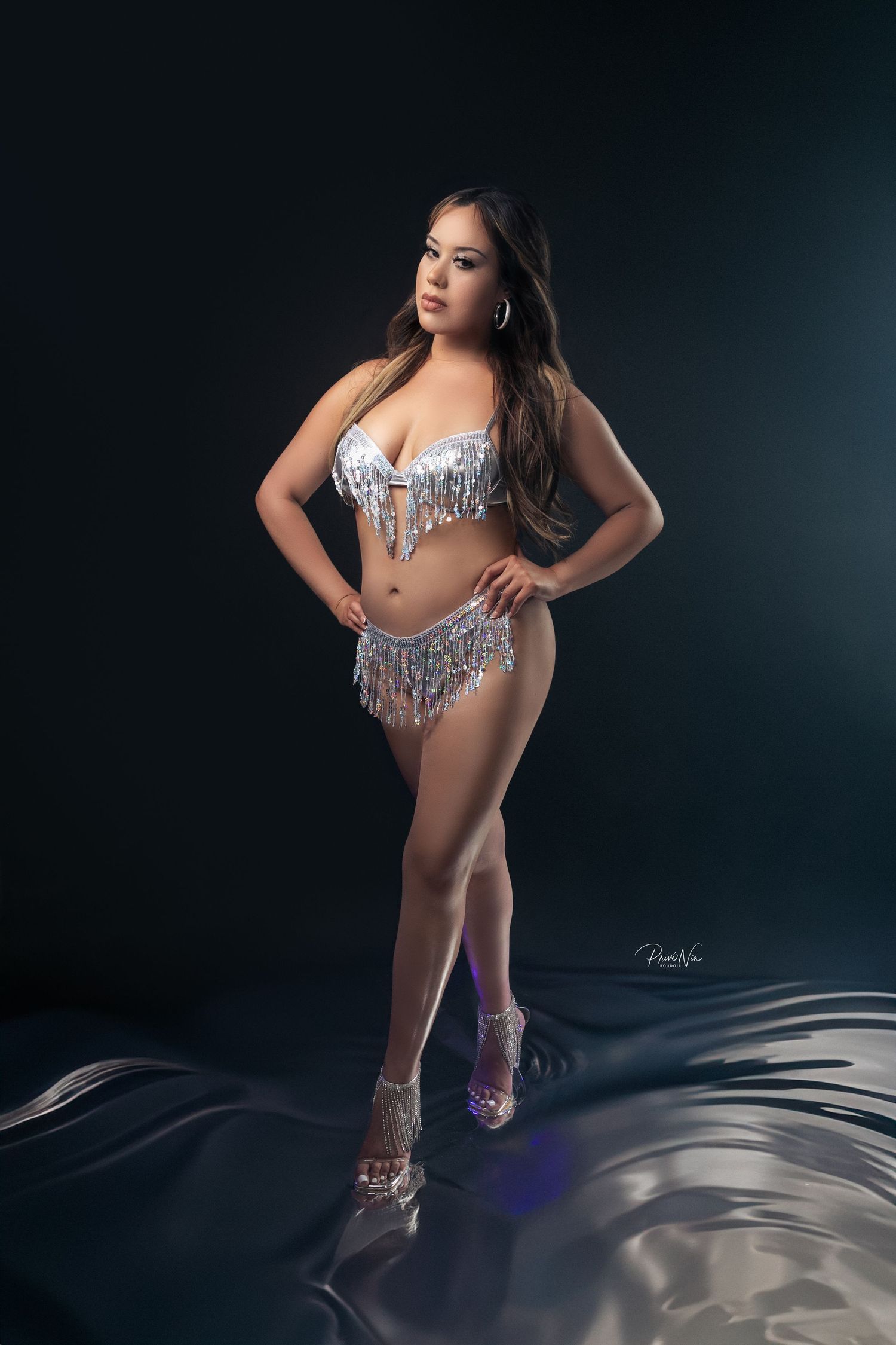 Artistic dance performance photos with dramatic lighting and flowing white costume against dark background.