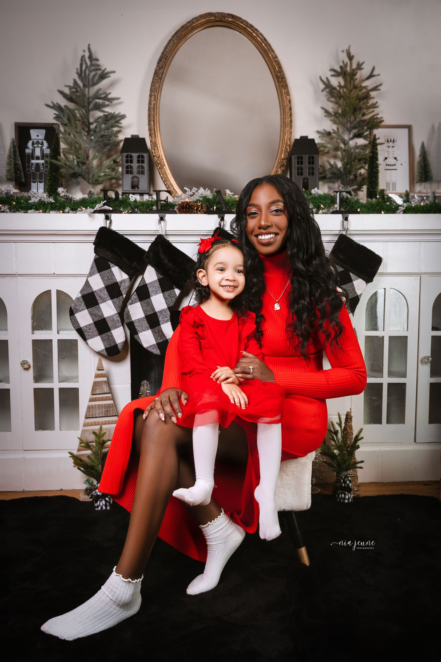 Holiday themed photos with Christmas stockings and festive red outfits.