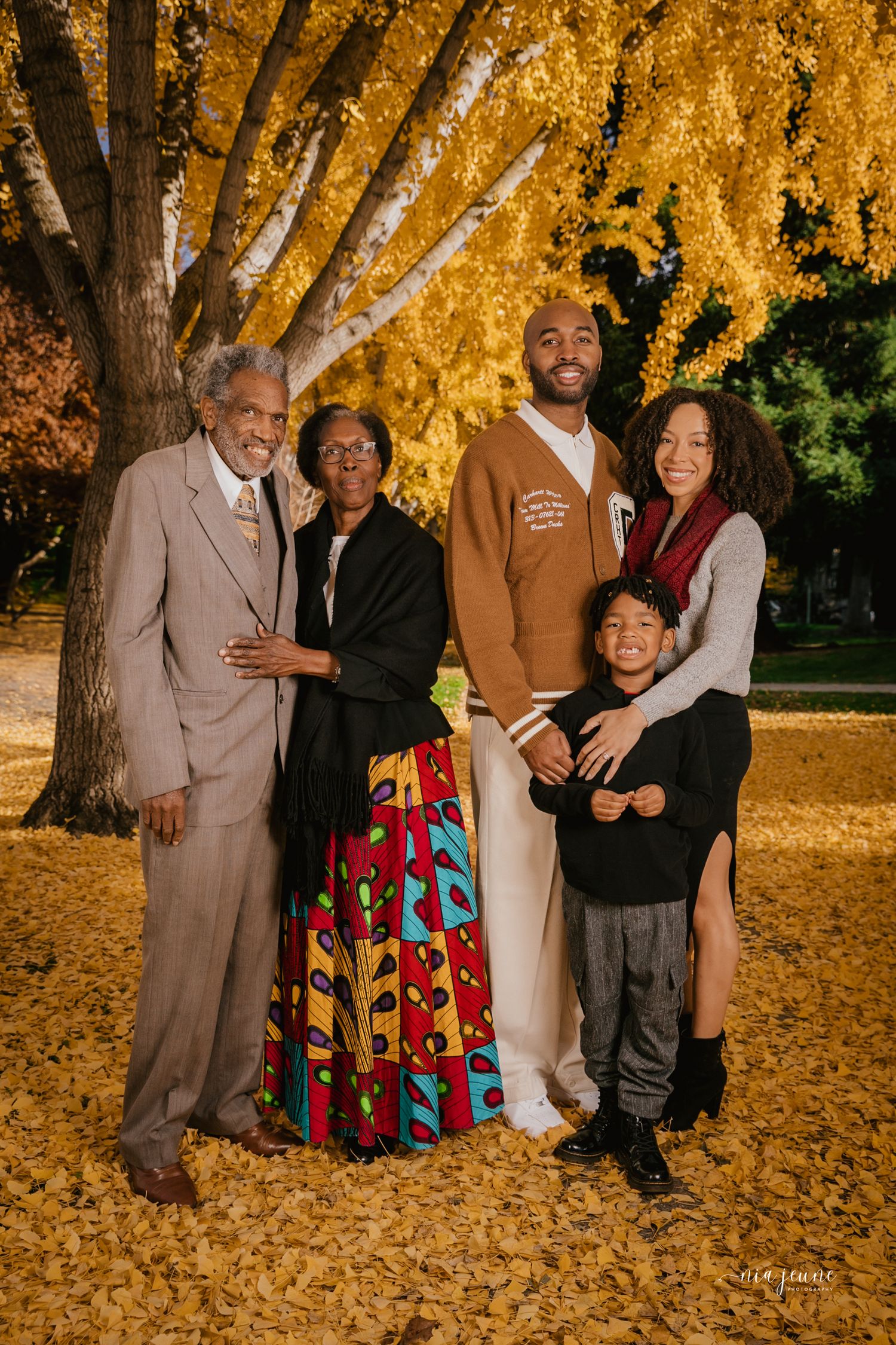 Family group photos under golden autumn trees with fallen leaves.