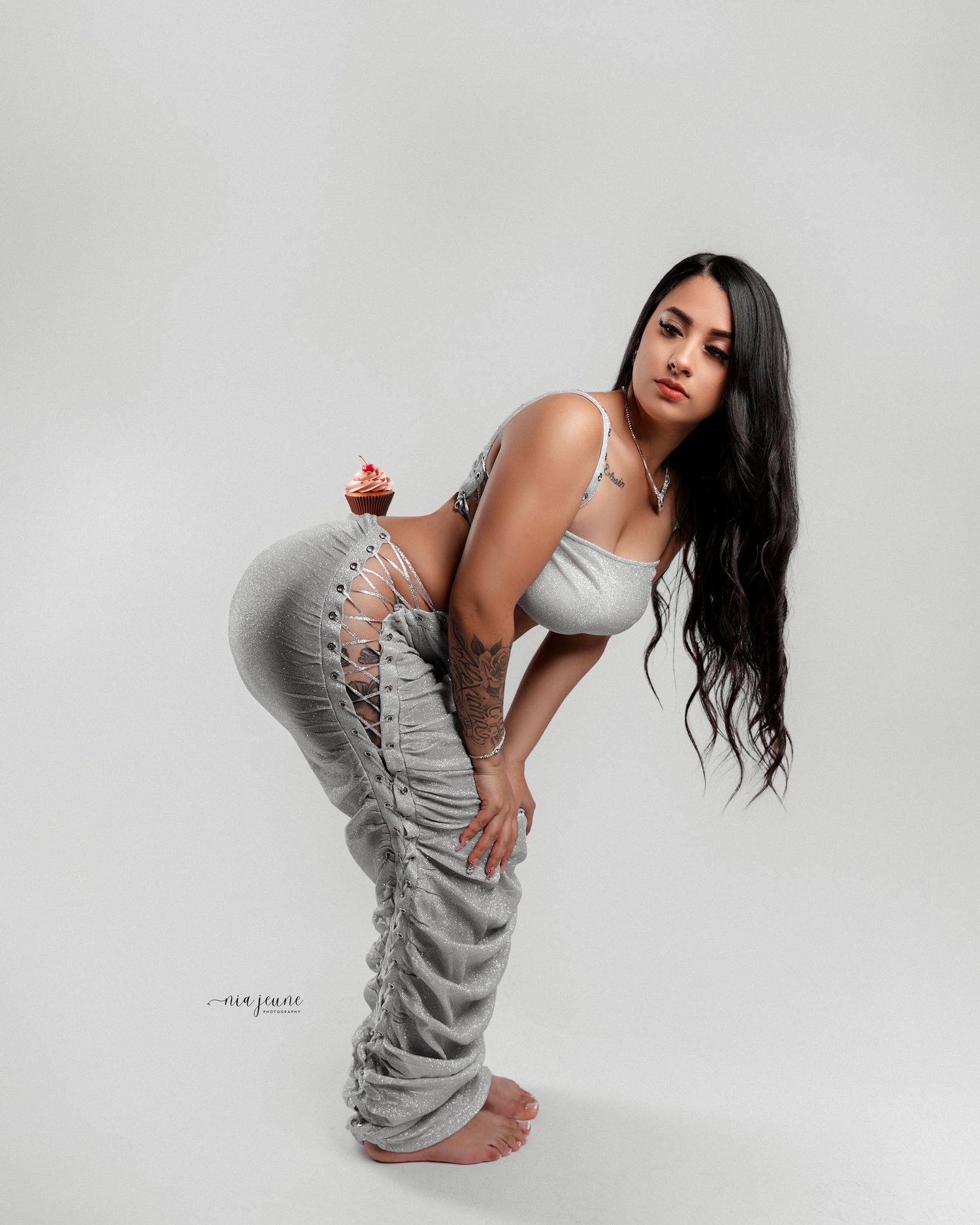 Artistic portrait series in a grey sweater dress against a minimal white backdrop.