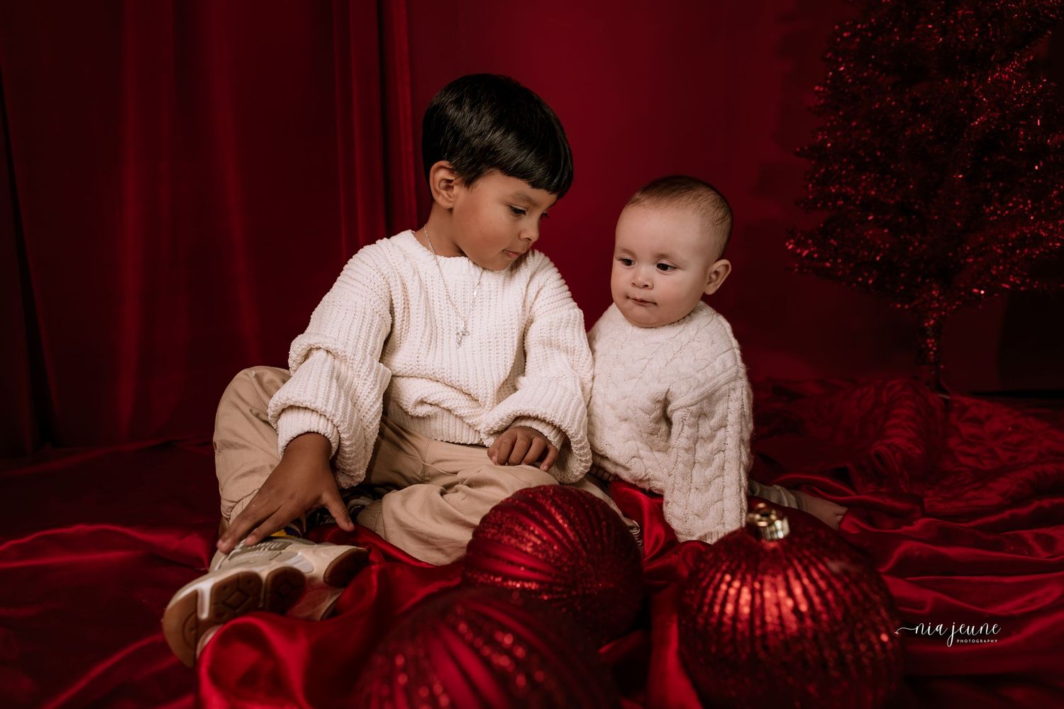 A collection of Christmas-themed photographs with shimmering red ornaments and festive decor.