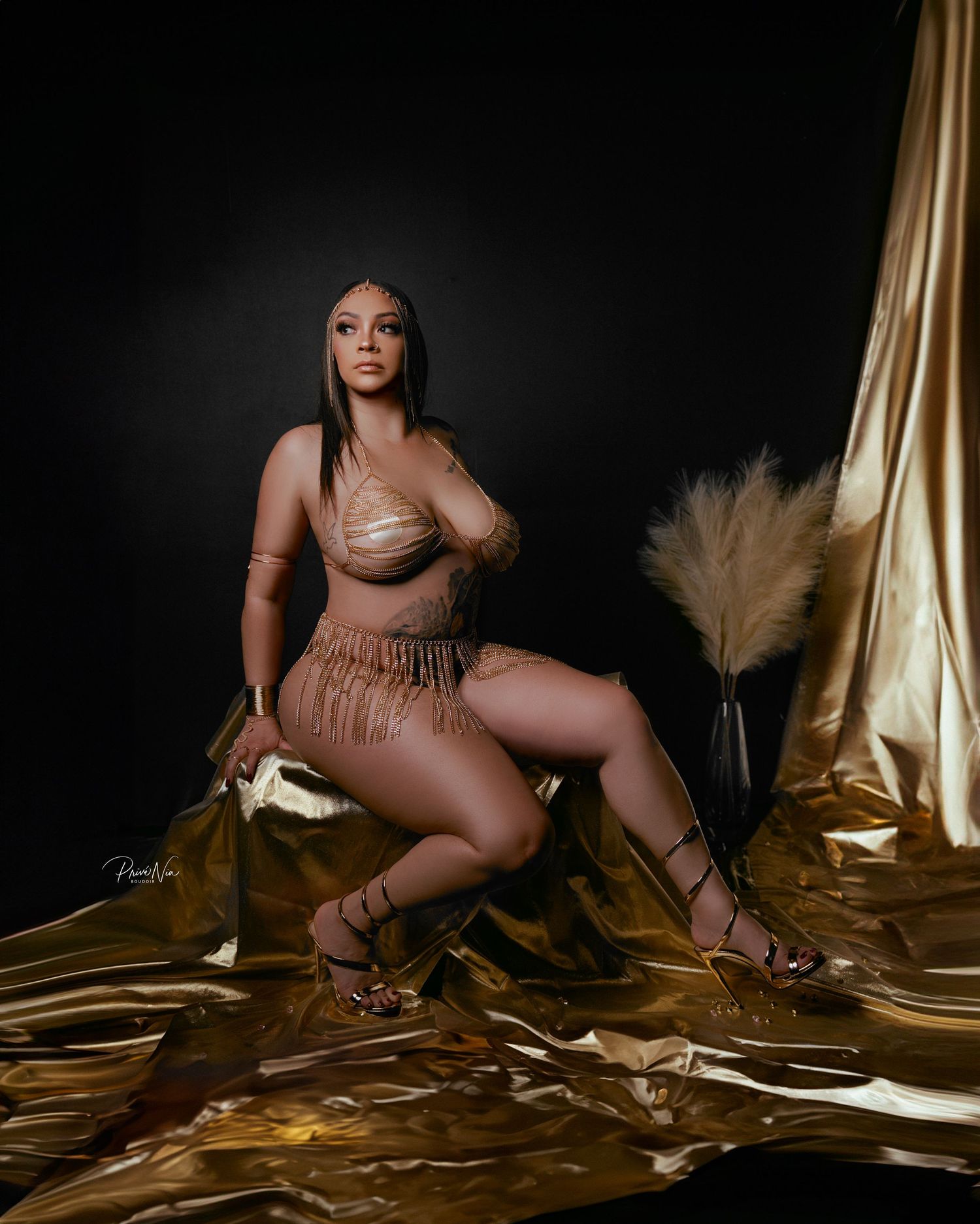 Glamour portrait on gold fabric with pampas grass decoration.