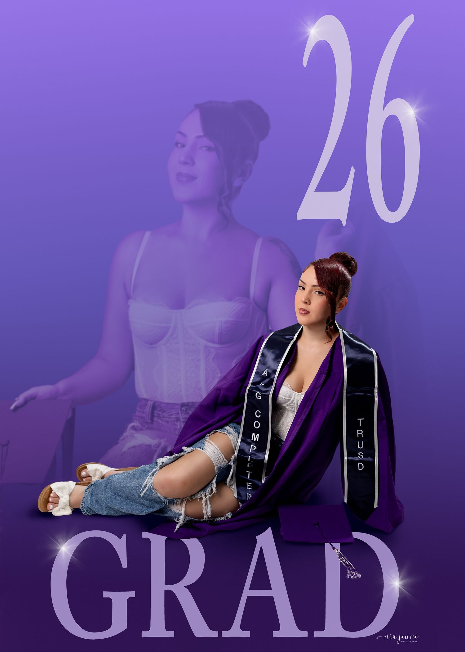 Young woman in graduation stole and jeans poses against purple gradient background with number 26 and GRAD text.