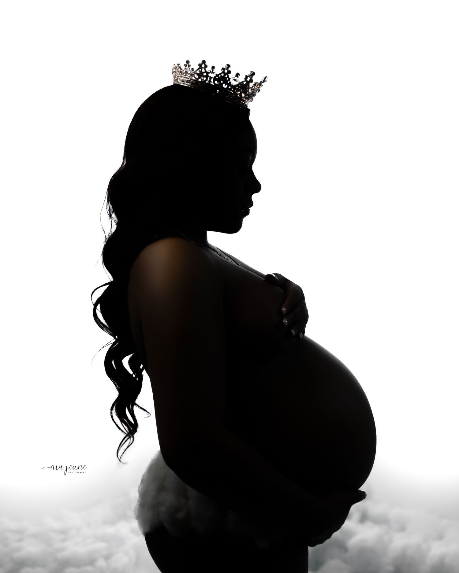 Silhouetted maternity photos with crown against white background.