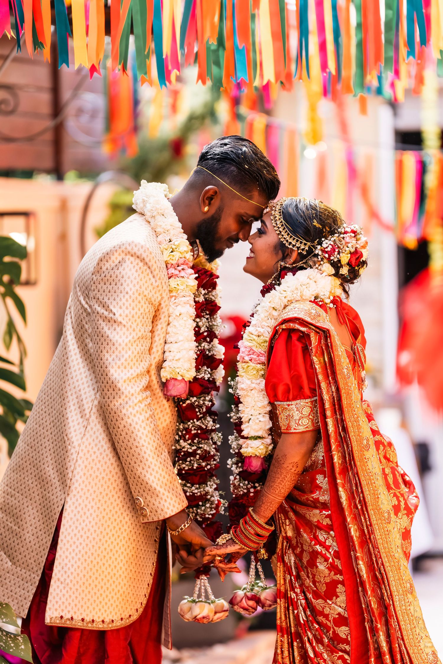 A series of photos showing a traditional Indian wedding ceremony with colorful decorations and floral garlands.
