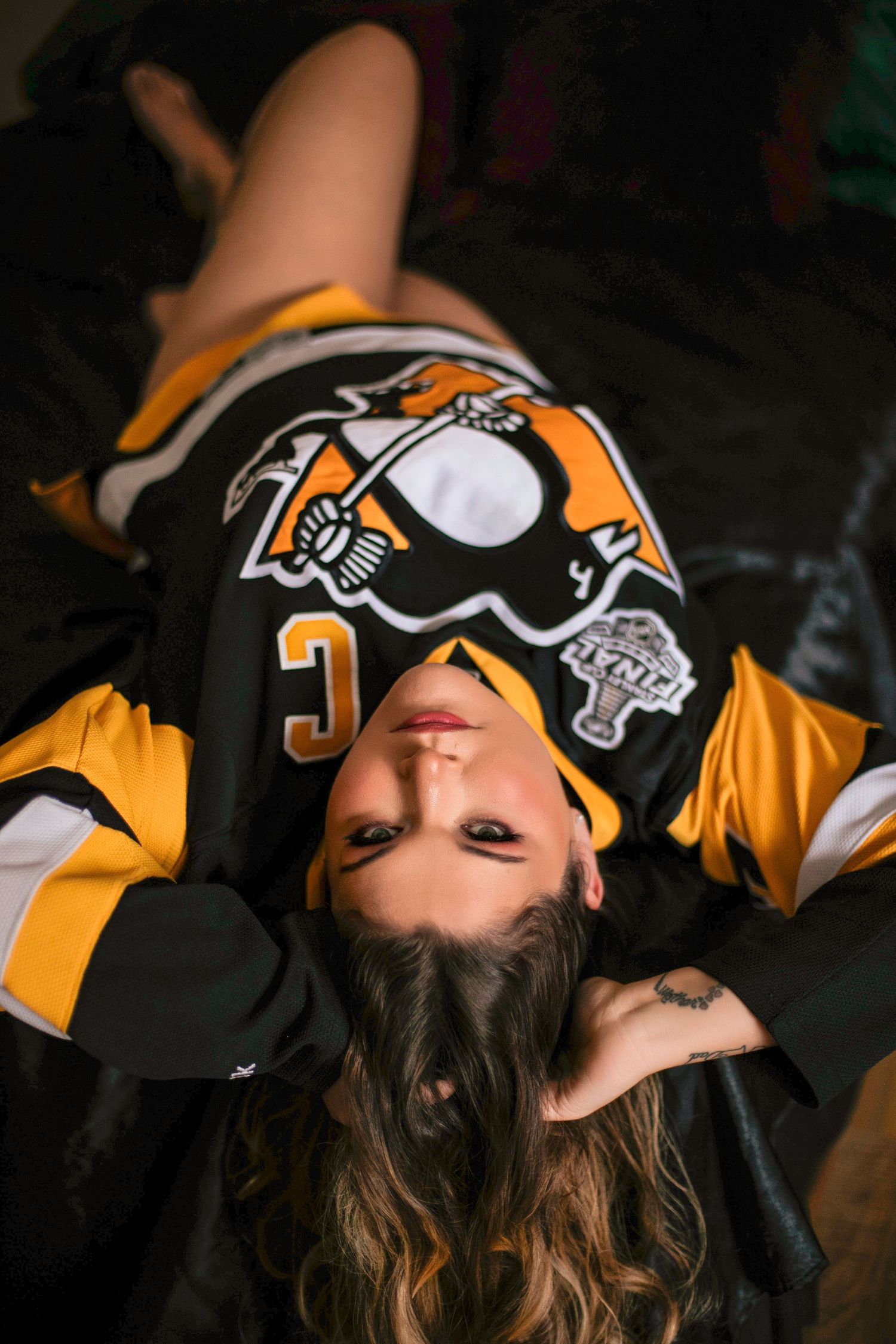 Pittsburgh Penguins hockey fan posed in team jersey.