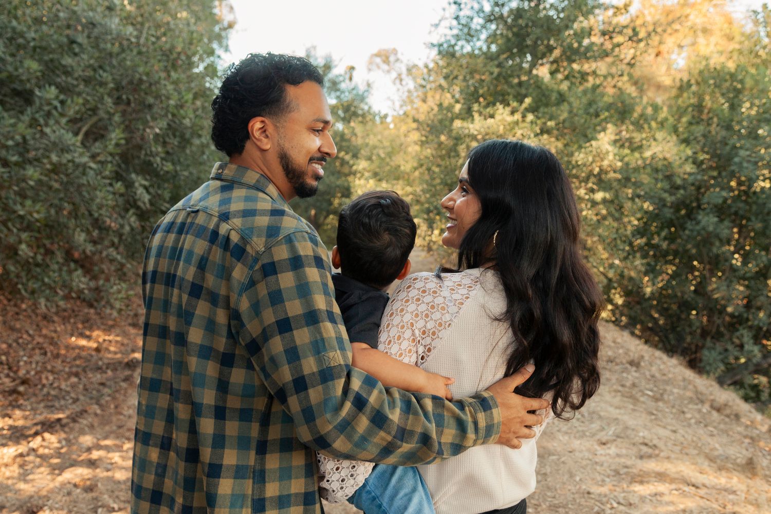 Romantic couple sharing playful moments in autumn outdoor setting.