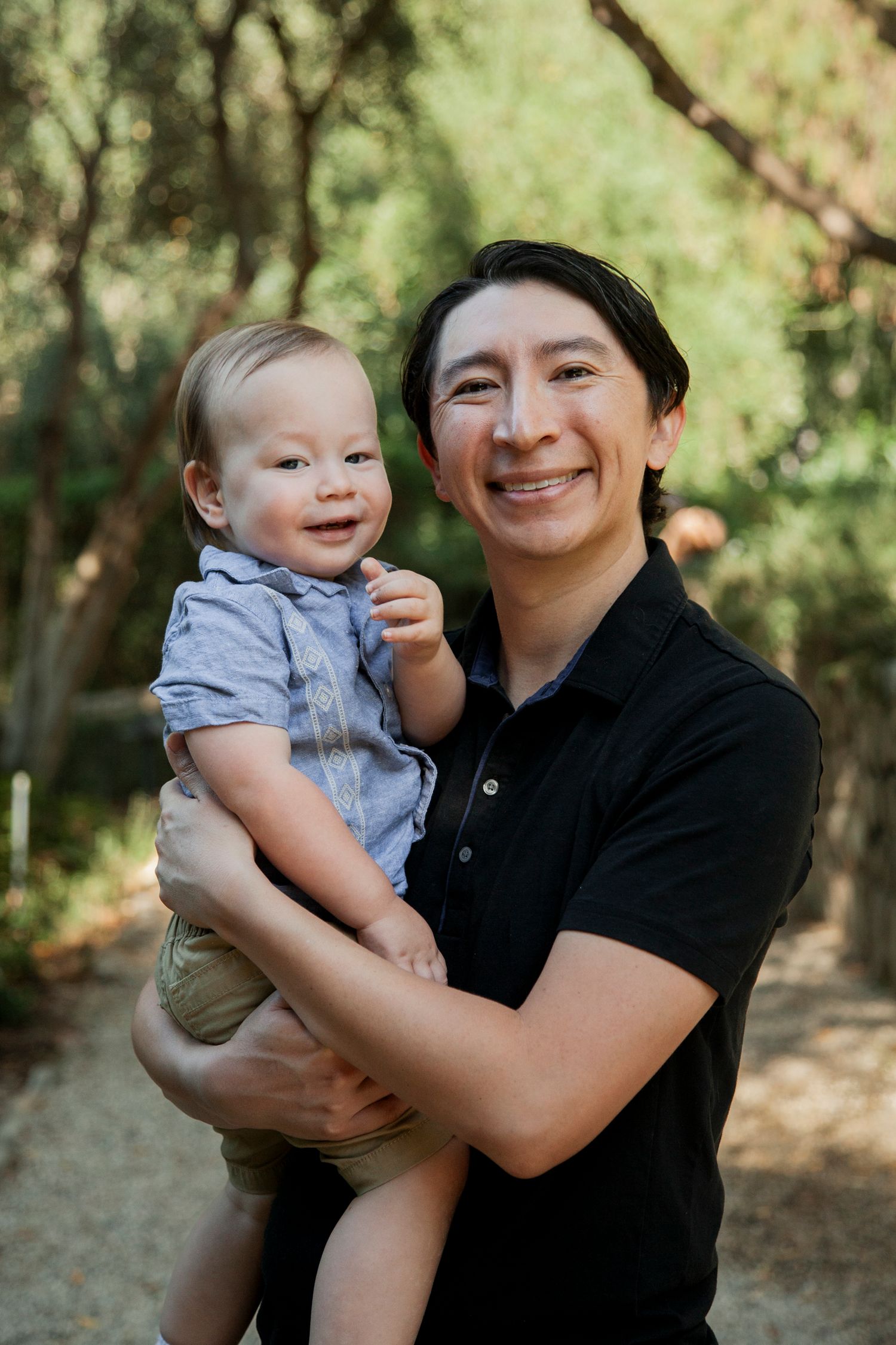 Parent and baby share joyful moments together in a series of outdoor portraits against a natural green background.
