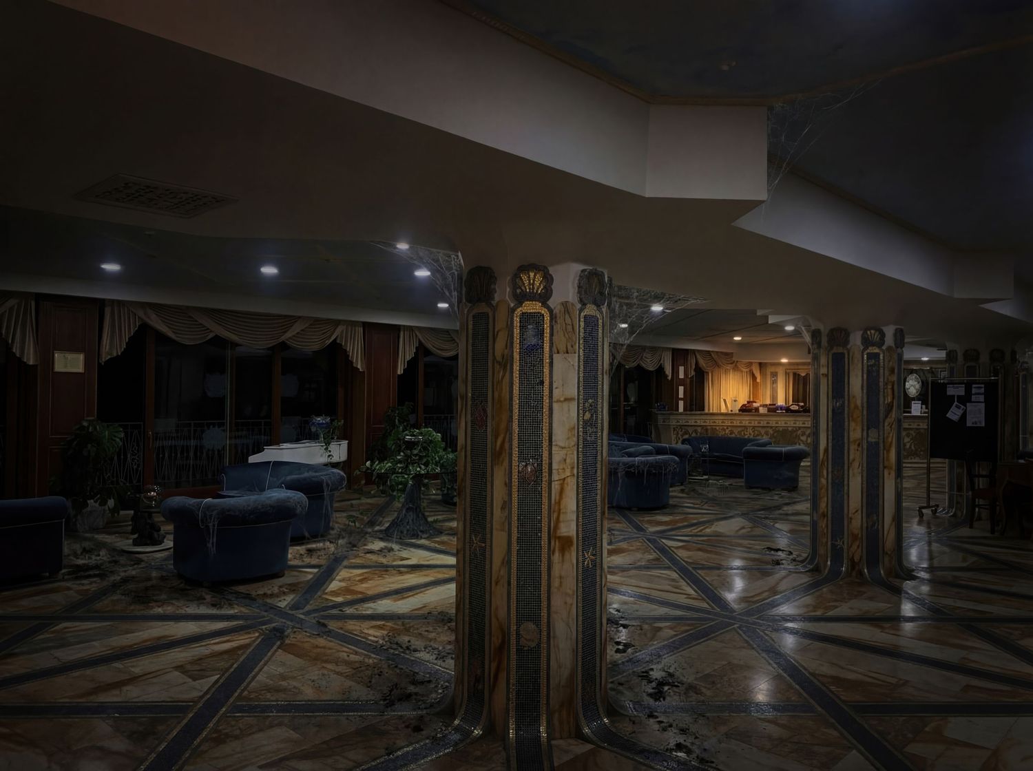 A panoramic view of a flooded underground parking garage with standing water reflecting off the ceiling.