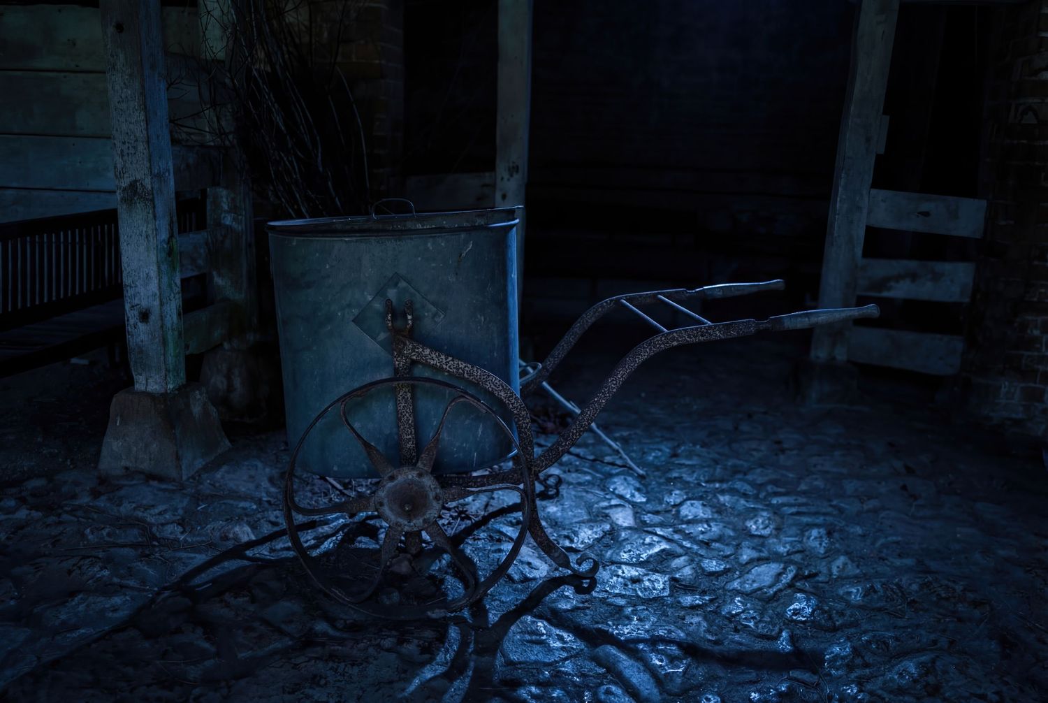 A dark and eerie abandoned hallway with scattered debris and peeling walls illuminated by blue light.