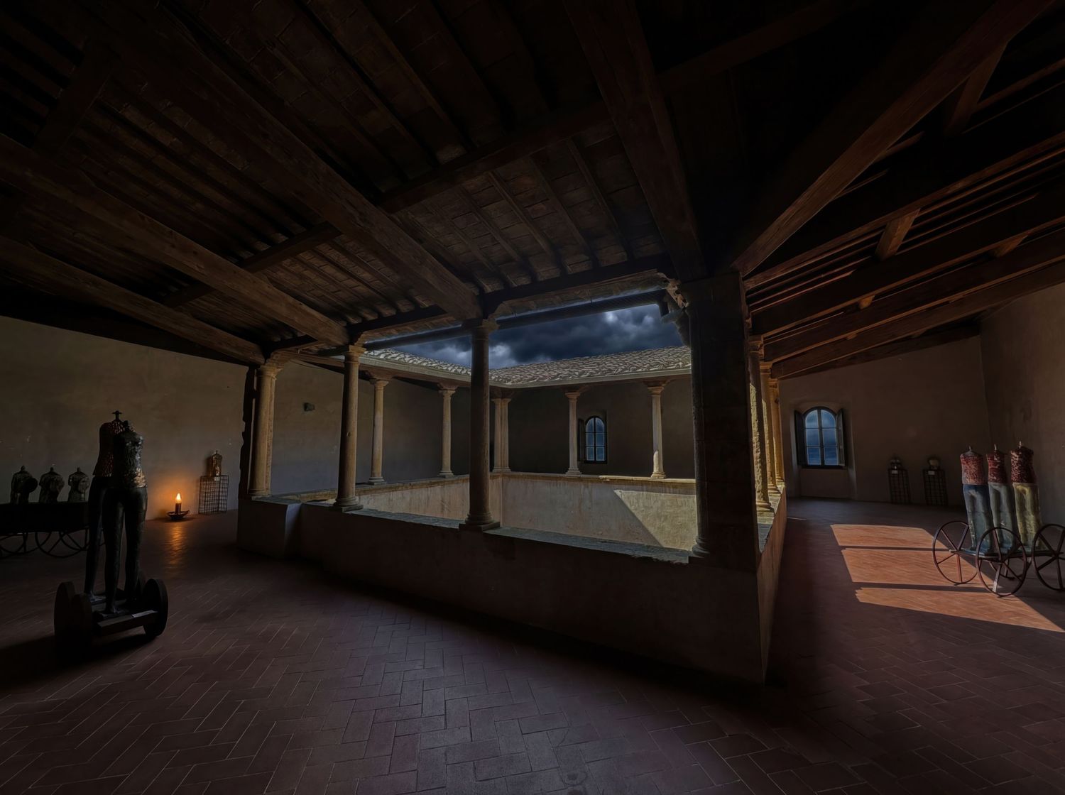 A panoramic view of an empty wooden attic space with exposed beams and dim lighting creates a moody atmosphere.
