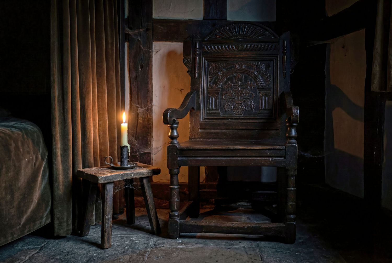Dark medieval room with ornate carved wooden chair, lit candle on small stool, and draped curtains.