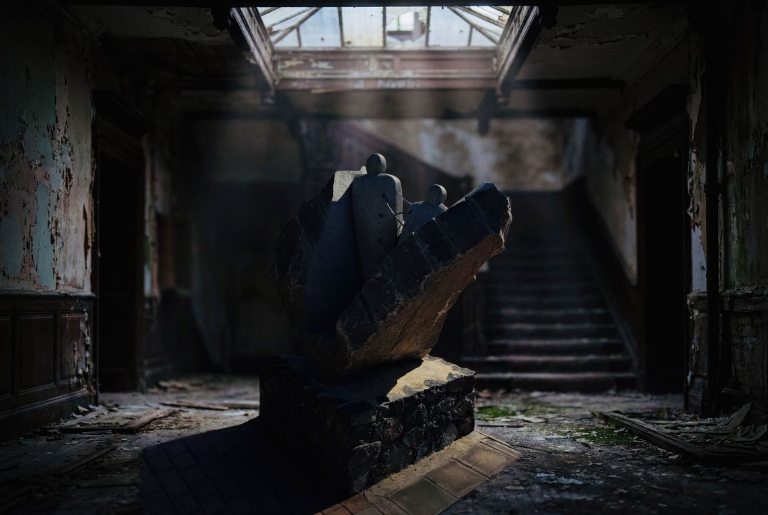 Dark and moody interior of an abandoned building with sunlight streaming through broken windows and debris-strewn floors.