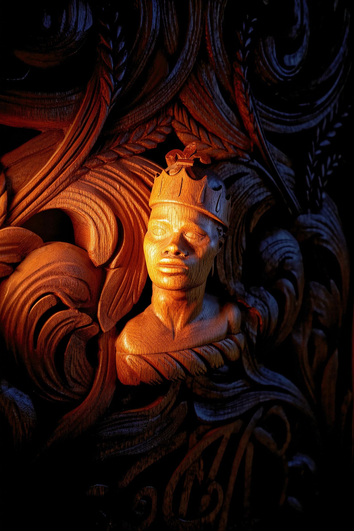 Dramatic wood carving sequence showing ornate sculptural details illuminated by warm lighting against a dark background.