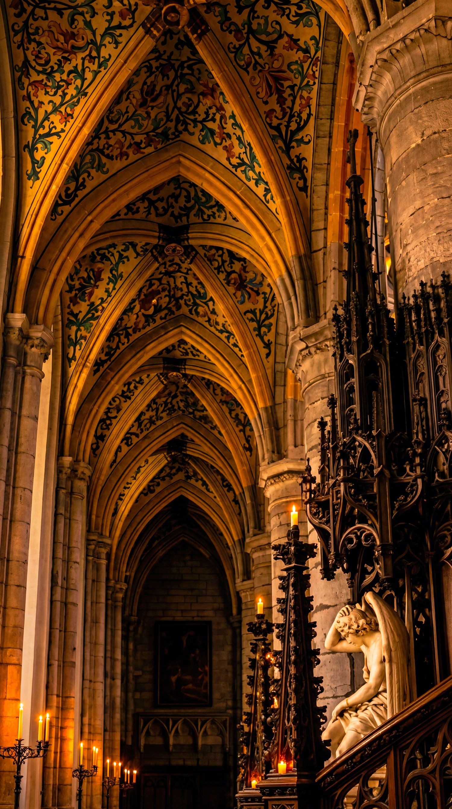 Gothic cathedral interior with ornate gilded vaulted ceiling, candlelit altar, and classical sculpture in warm amber light.