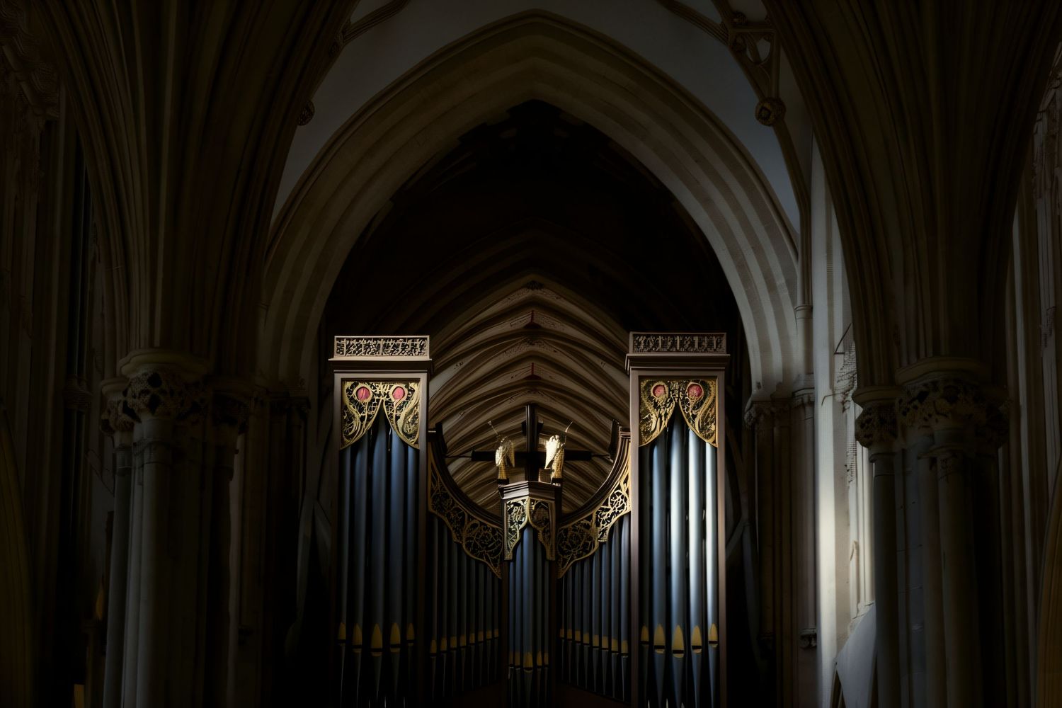 Church organ pipes within a Gothic stone archway illuminated by dramatic lighting in a cathedral interior.