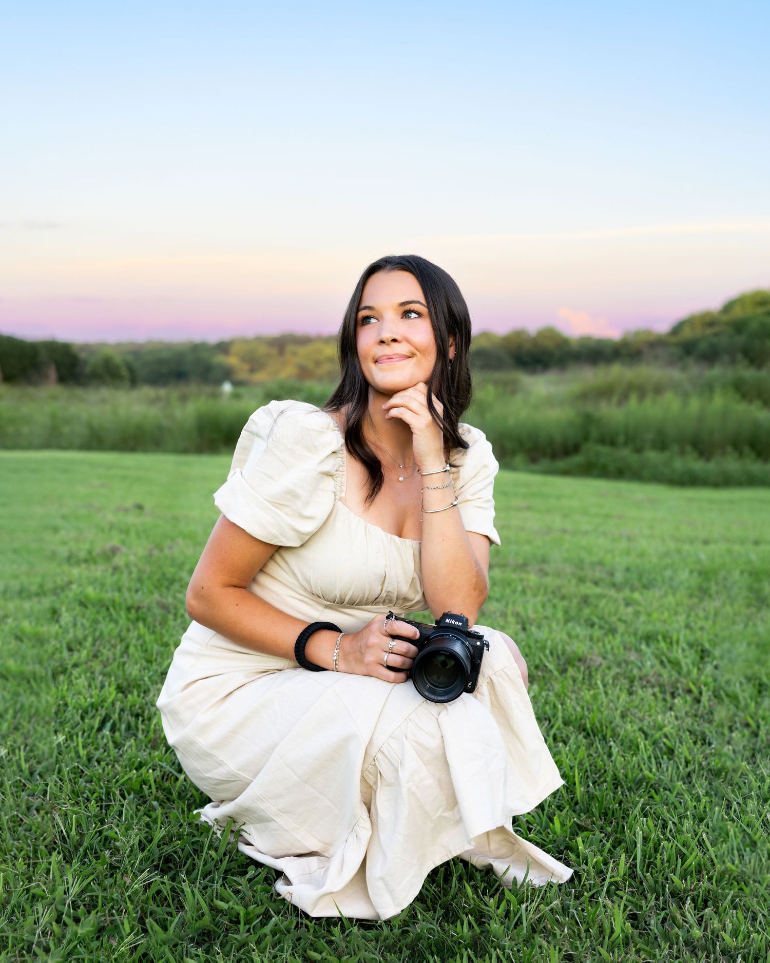 Photographer Molly DuBois smiling at camera outdoors in Raleigh NC