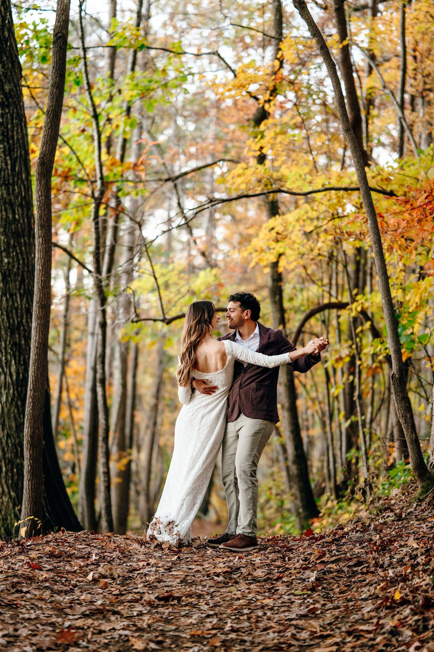 Couple walking through autumn foliage in Raleigh North Carolina