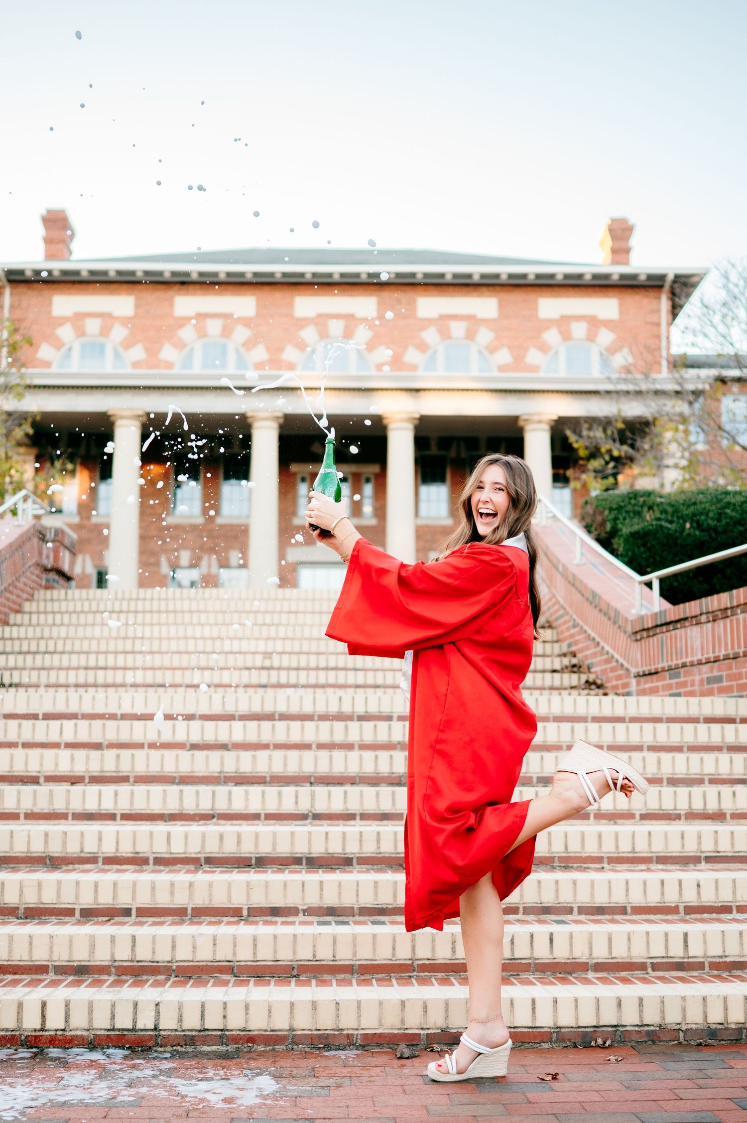 Champagne pop graduation photos in Raleigh NC at the Court of Carolina