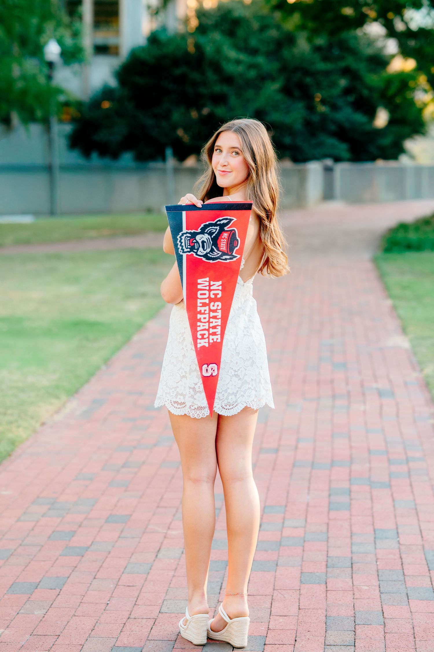 Graduate walking through Raleigh NC during portrait session