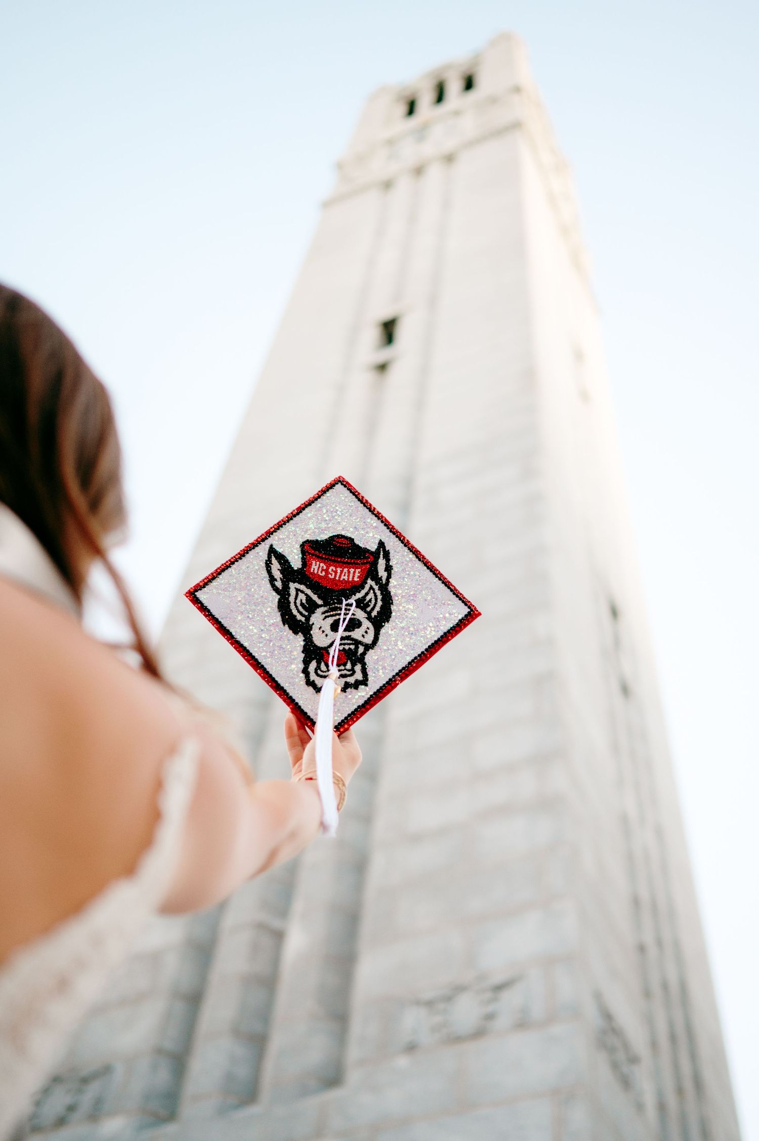 NC State Bell Tower graduation photos with cap and gown