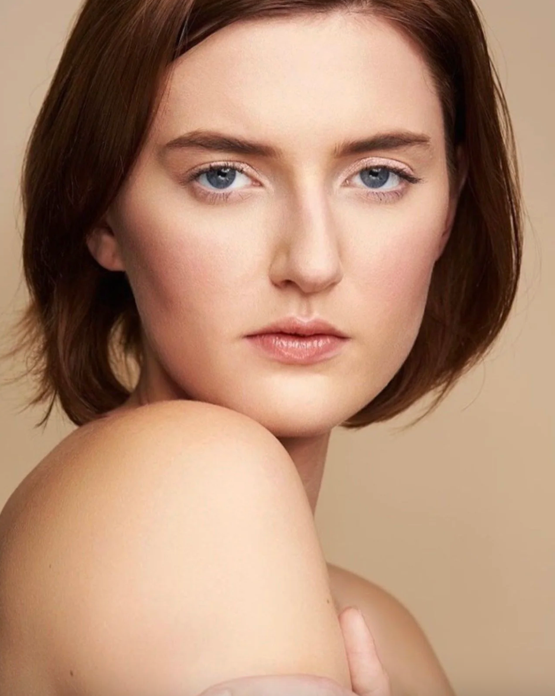 Clean beauty portraits showing natural makeup and short brown hair against neutral backdrop.