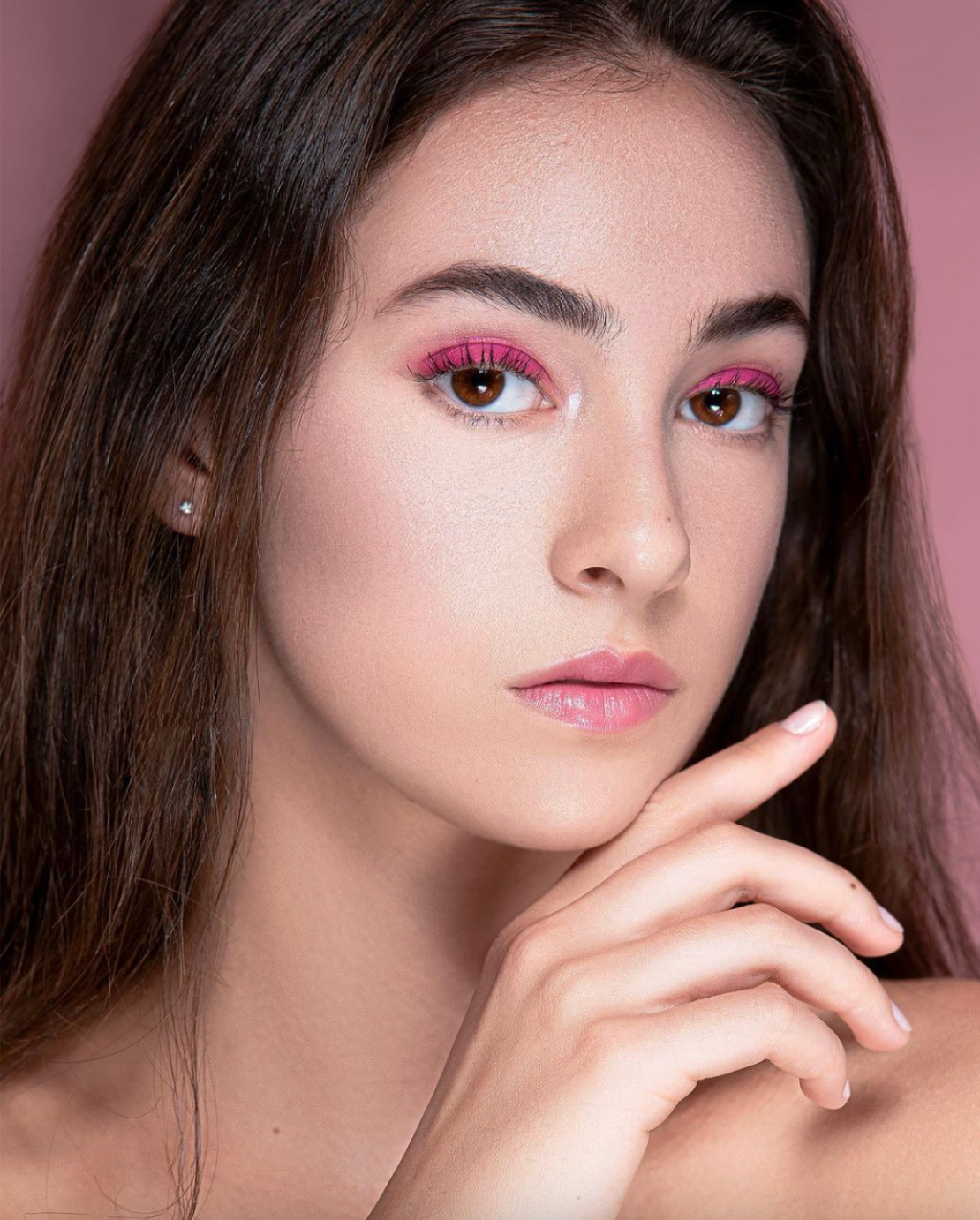 Soft beauty portraits featuring pink eye makeup and glossy lips against rosy background.