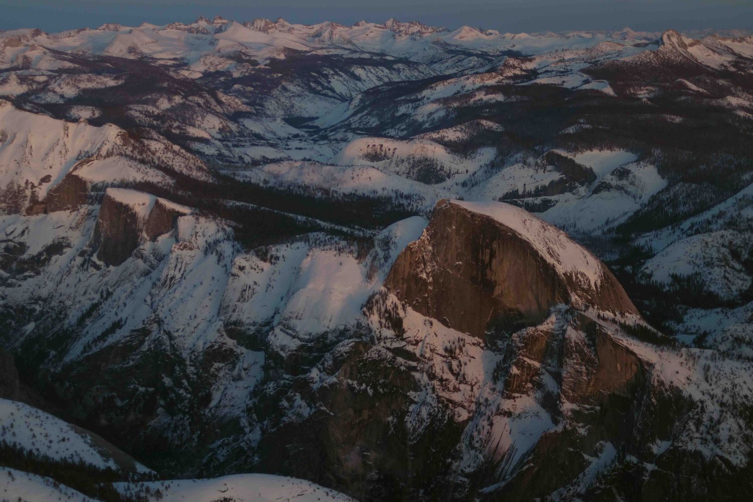 Snow topped half dome in yosemite as seen from the sky