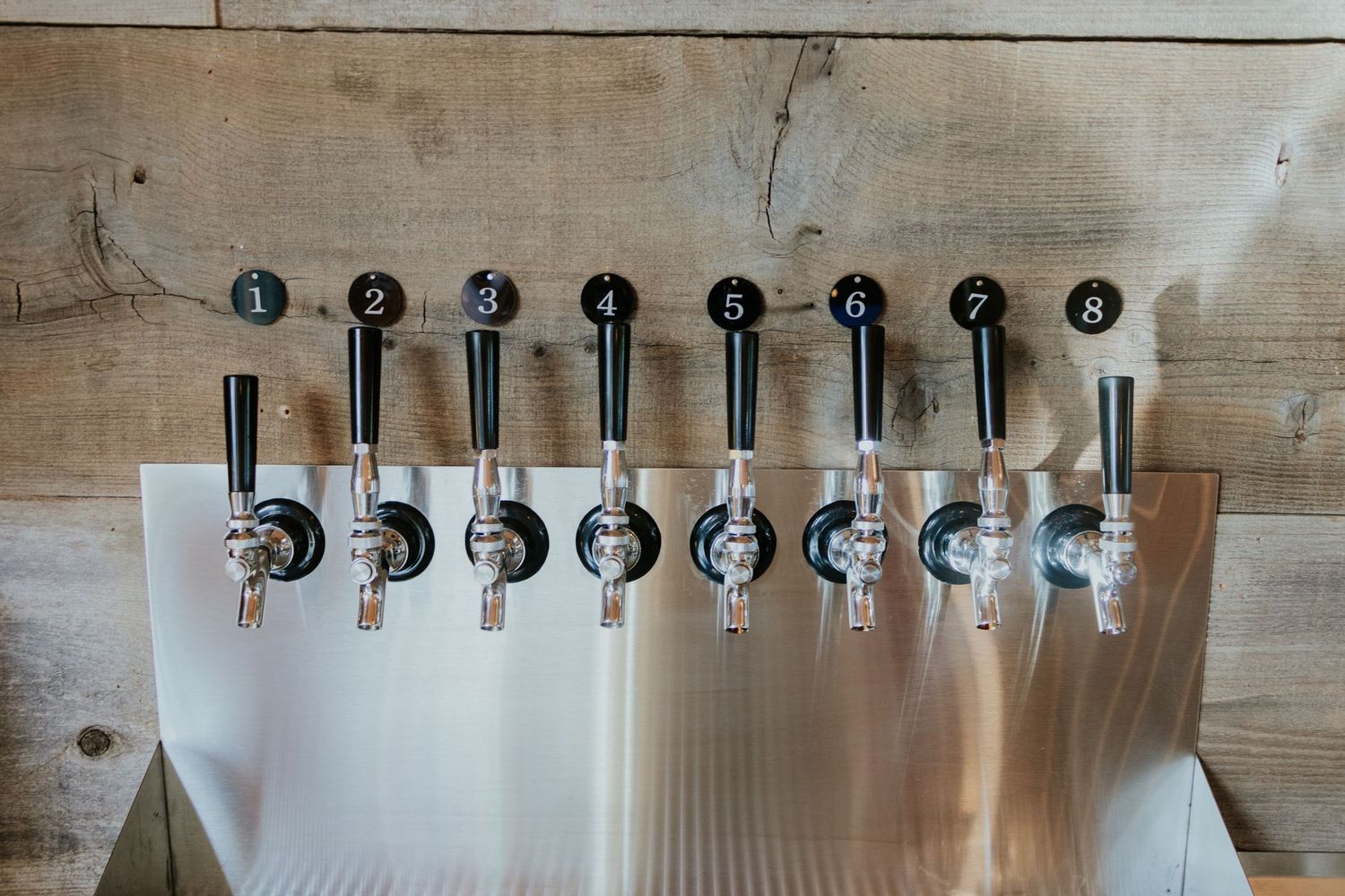 close up of beer taps in a tap room
