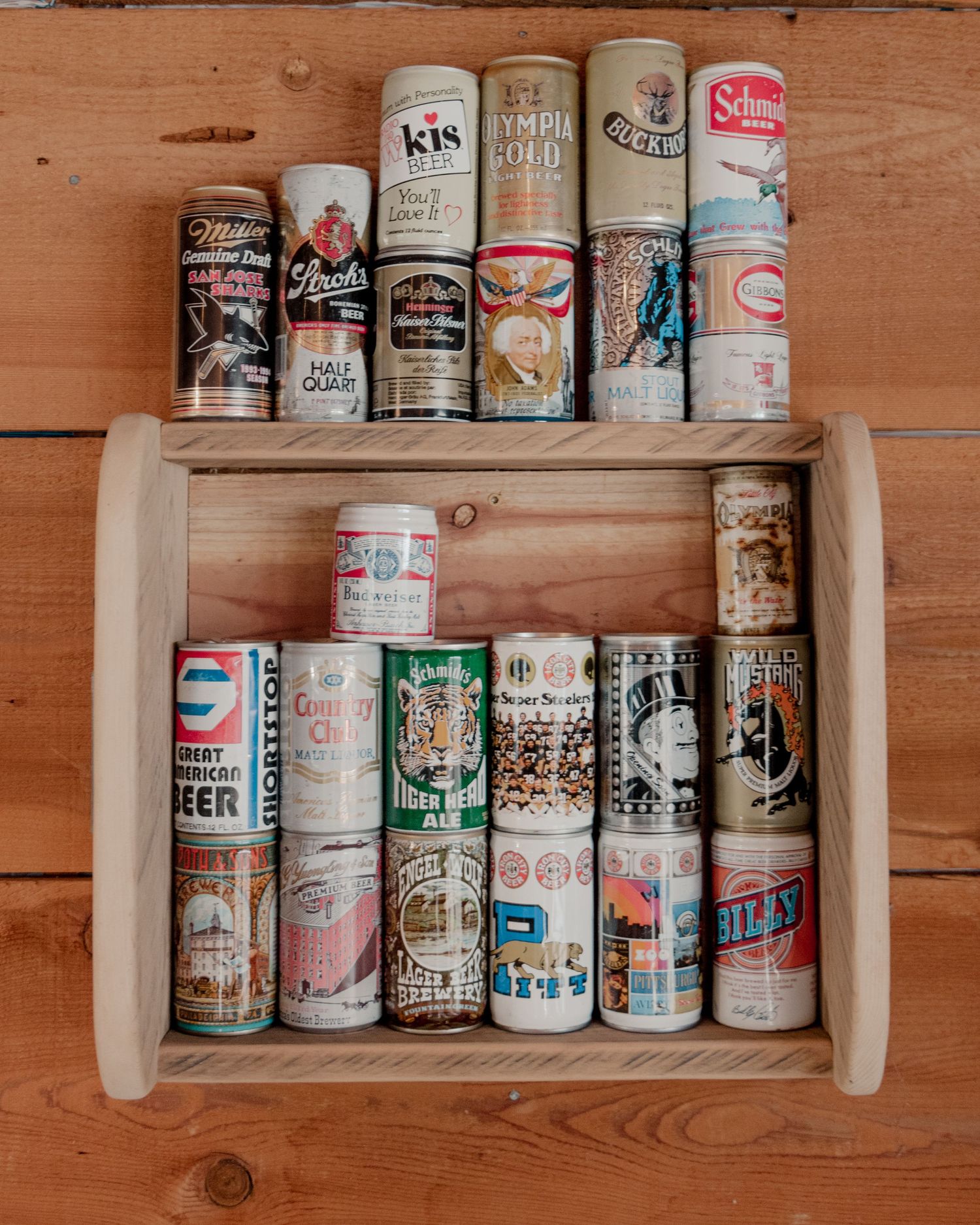 shelf lined with vintage beer cans