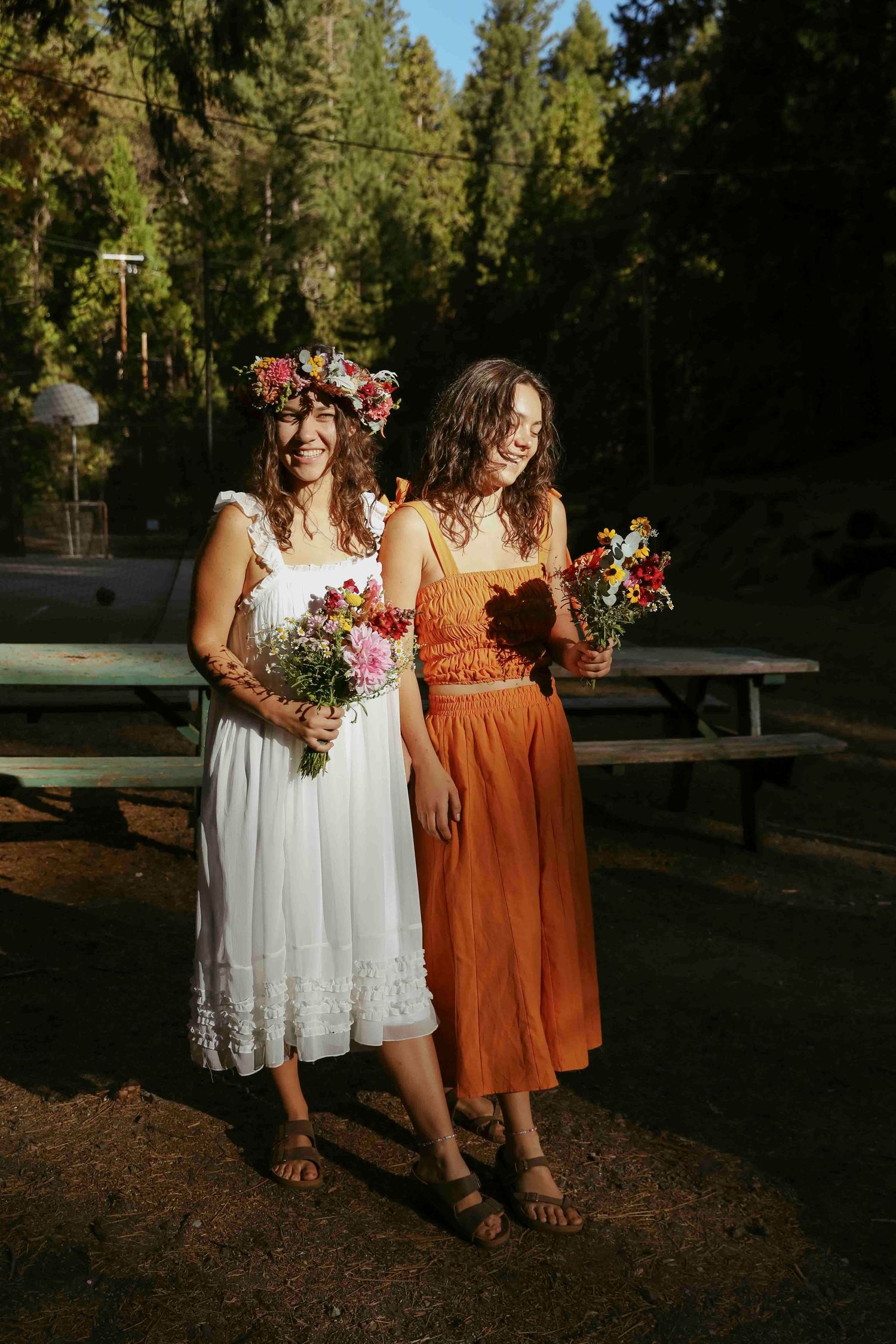 bride and maid of honor show off their dresses together.