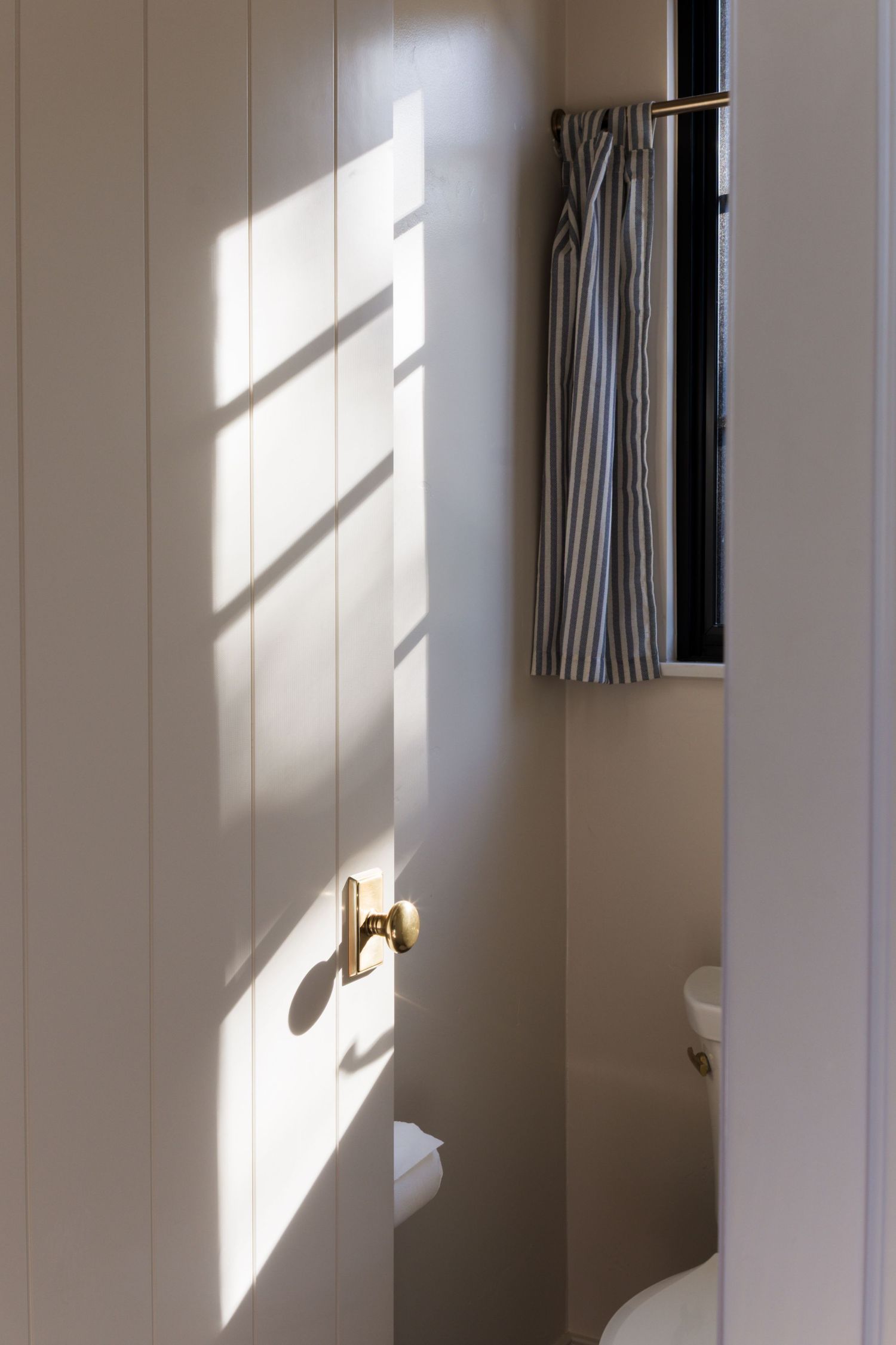 Light from window hits door with brass knob