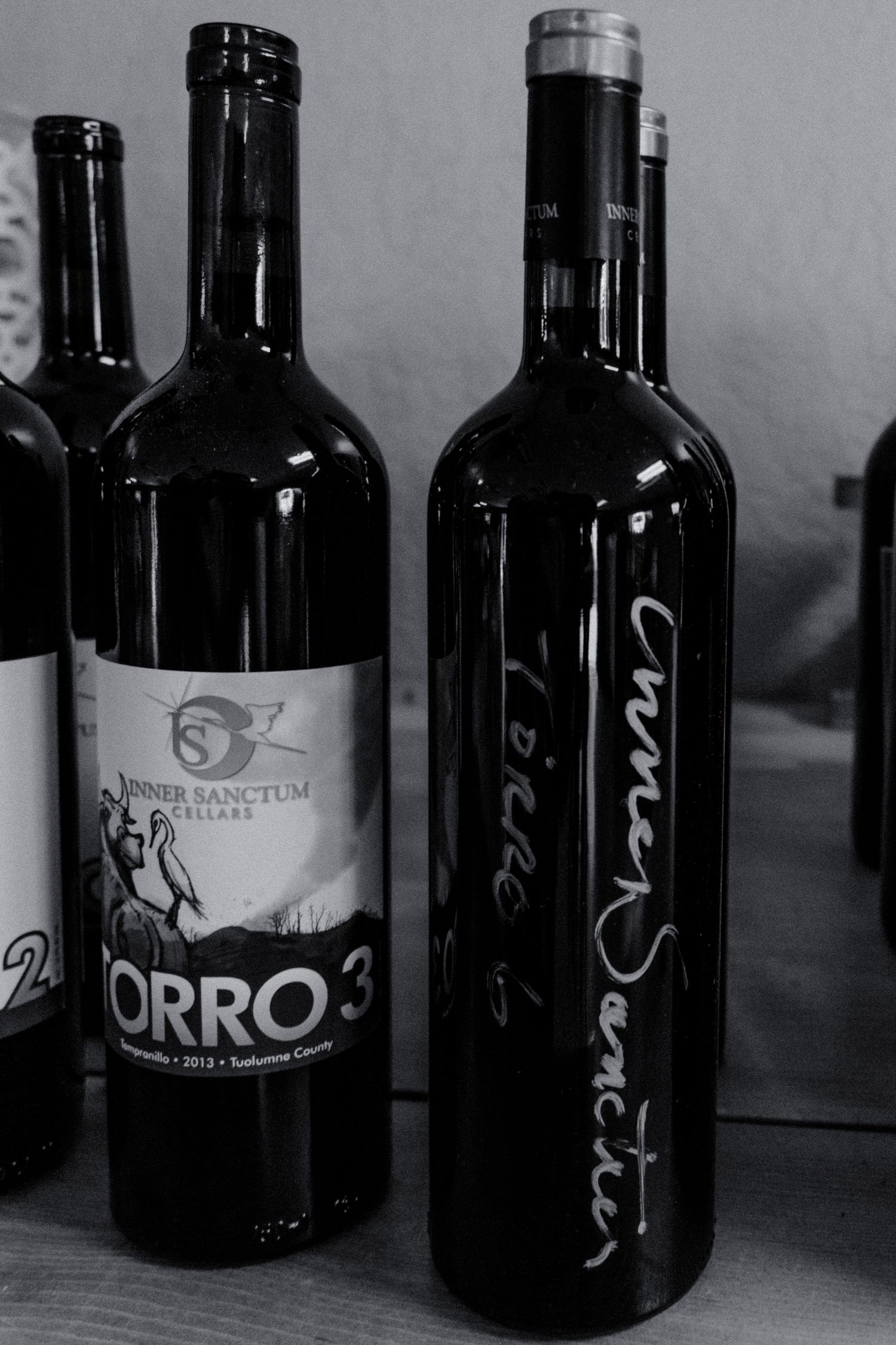 b+w photo of wine bottles