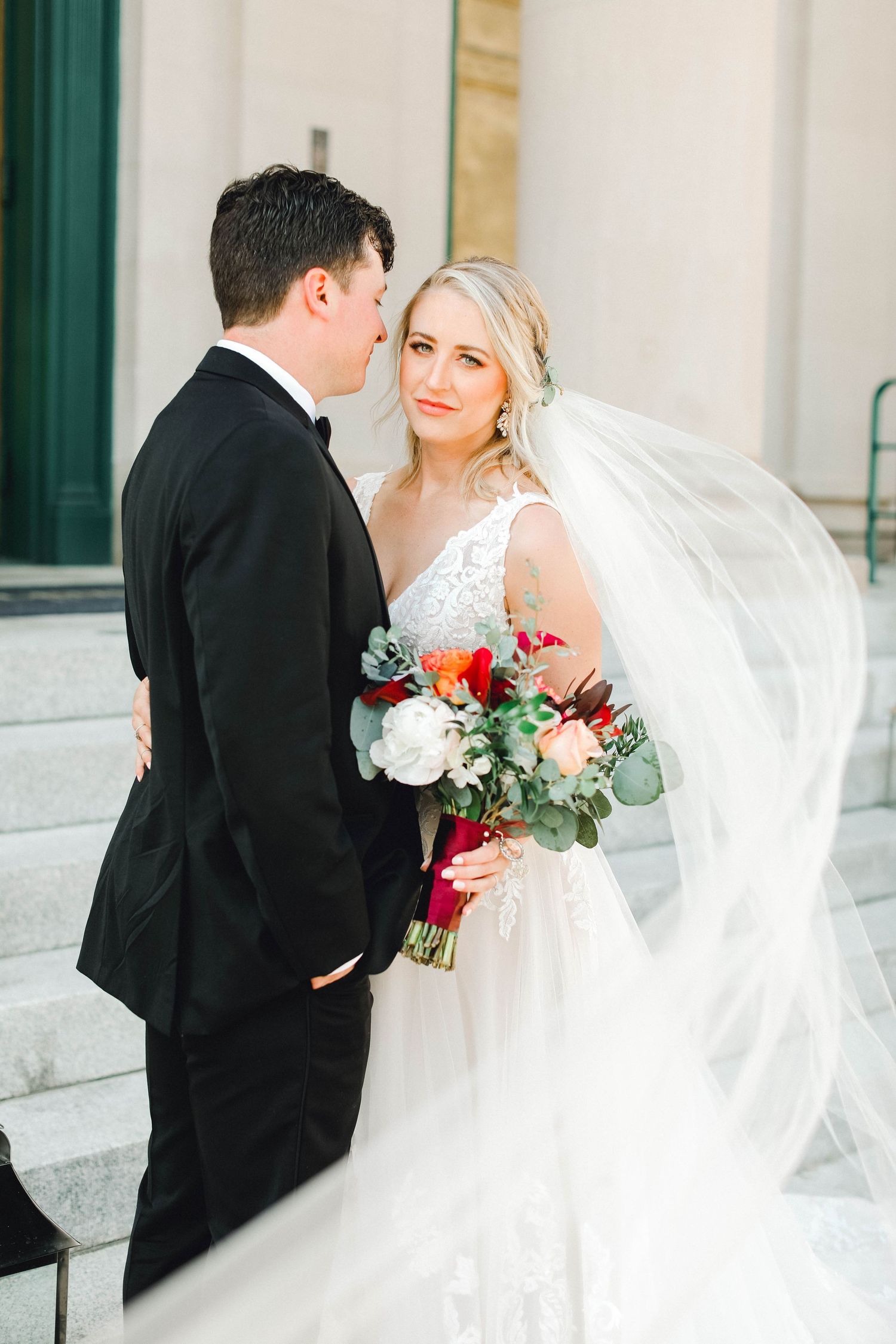 A romantic wedding moment captured in a series of photos showing the couple with flowing white veil and red bouquet.