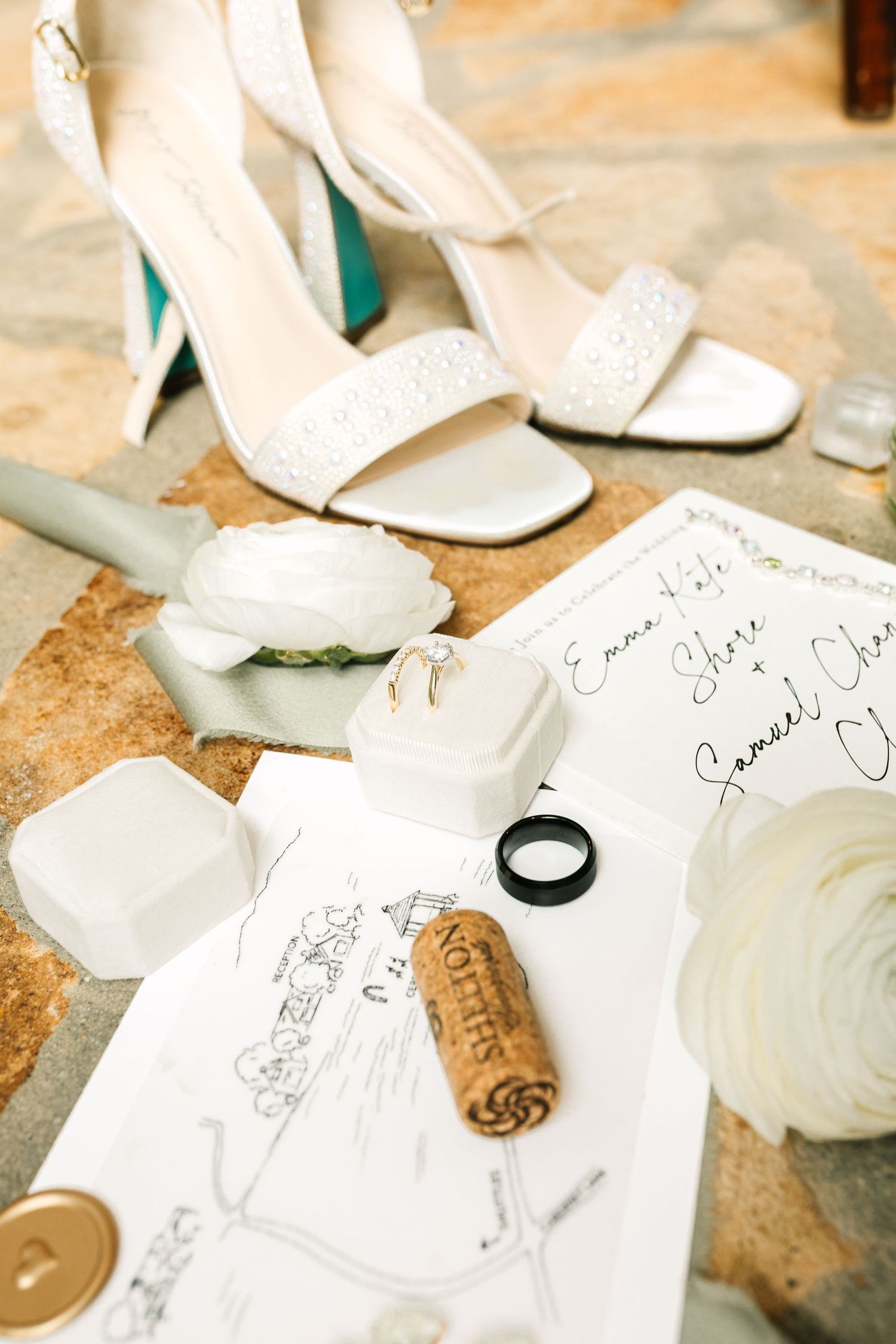 Wedding details including white shoes, rings, and handwritten notes arranged artistically.
