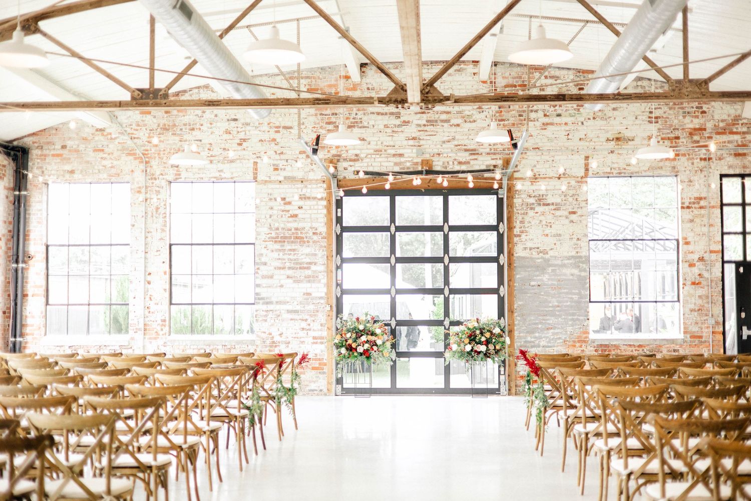 Industrial wedding venue with exposed beams and brick walls.