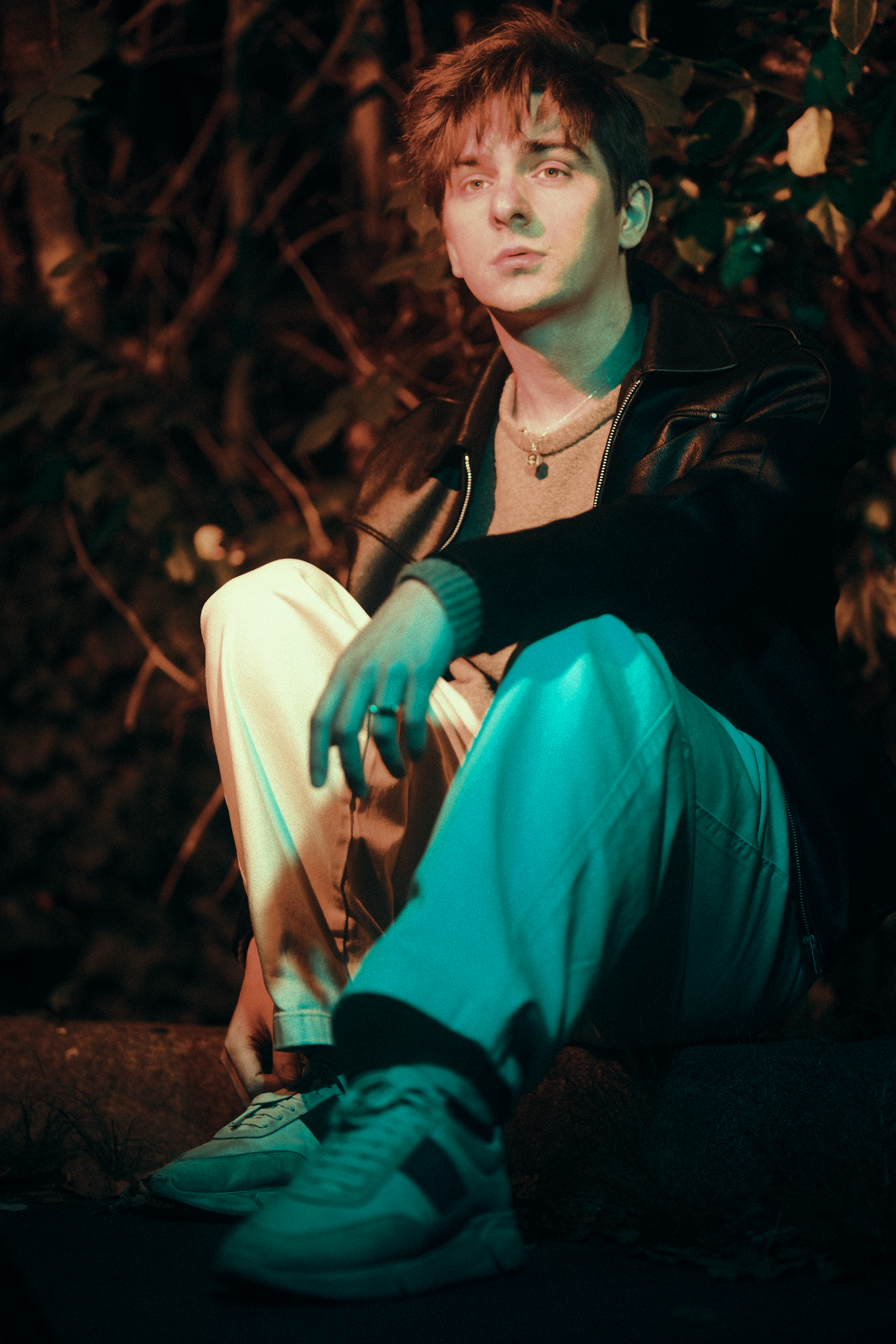 Moody nighttime portrait sequence in teal tones with atmospheric lighting.