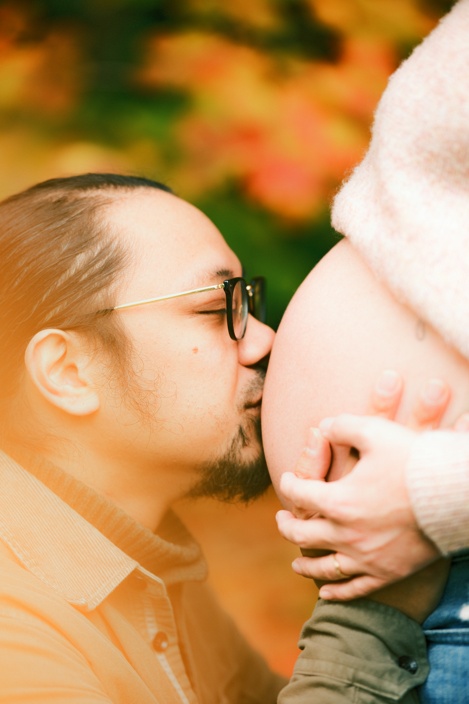 Intimate close-up sequence of a tender kiss captured in warm autumn lighting.