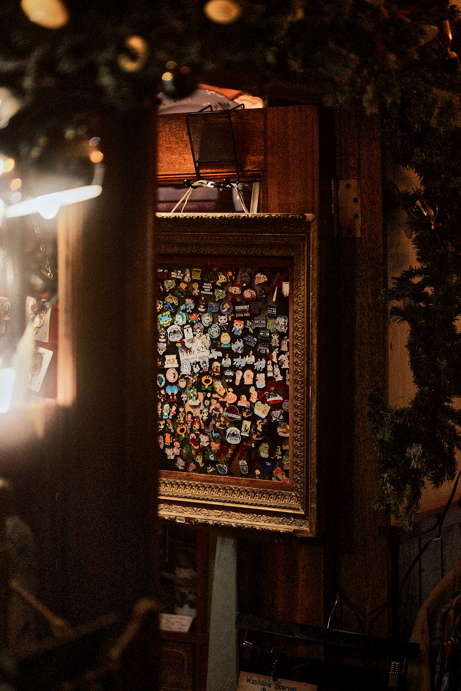 Dark interior wall with illuminated framed collage of photographs.