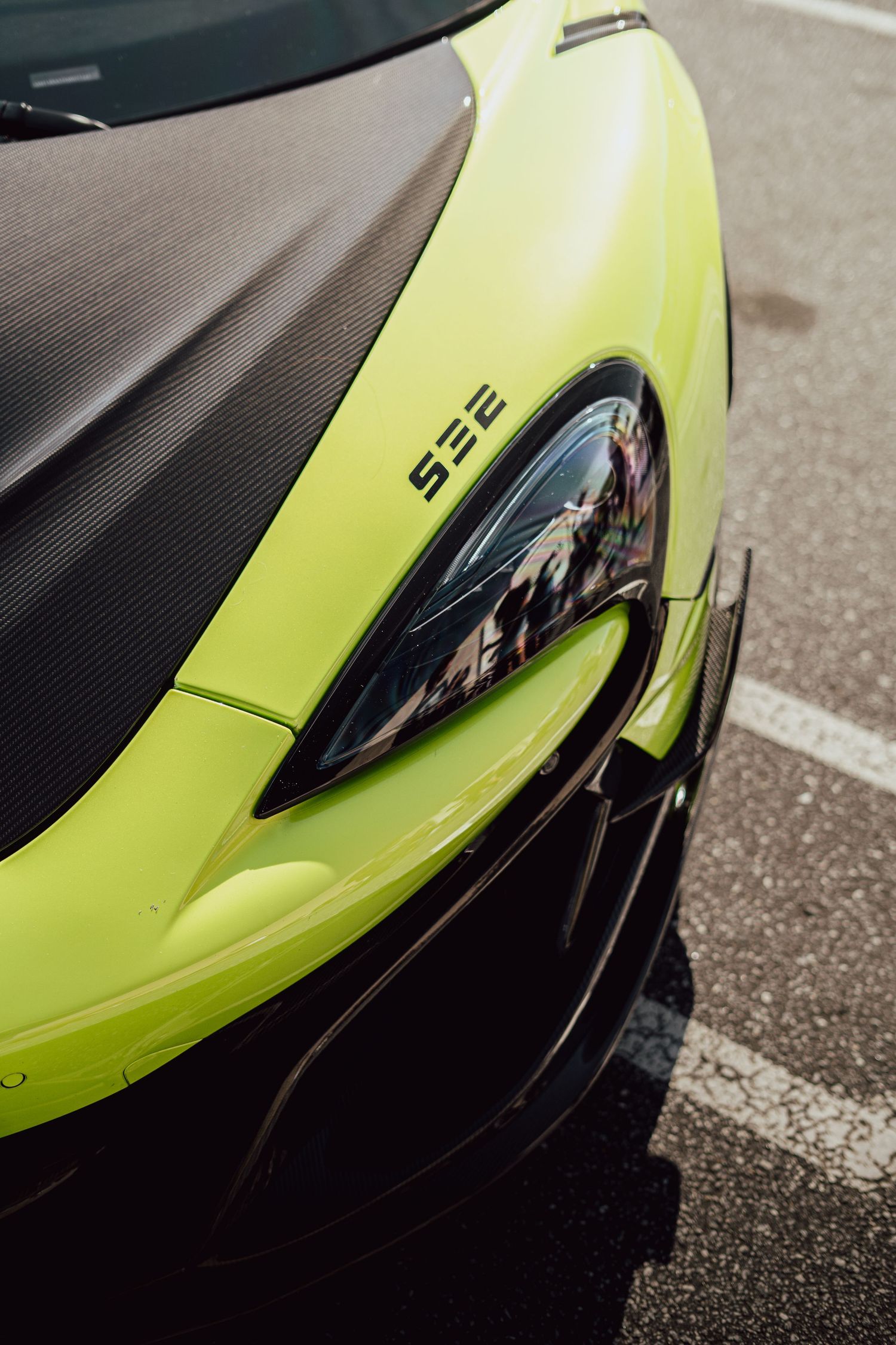Neon green McLaren supercar's sleek side profile and aerodynamic details.