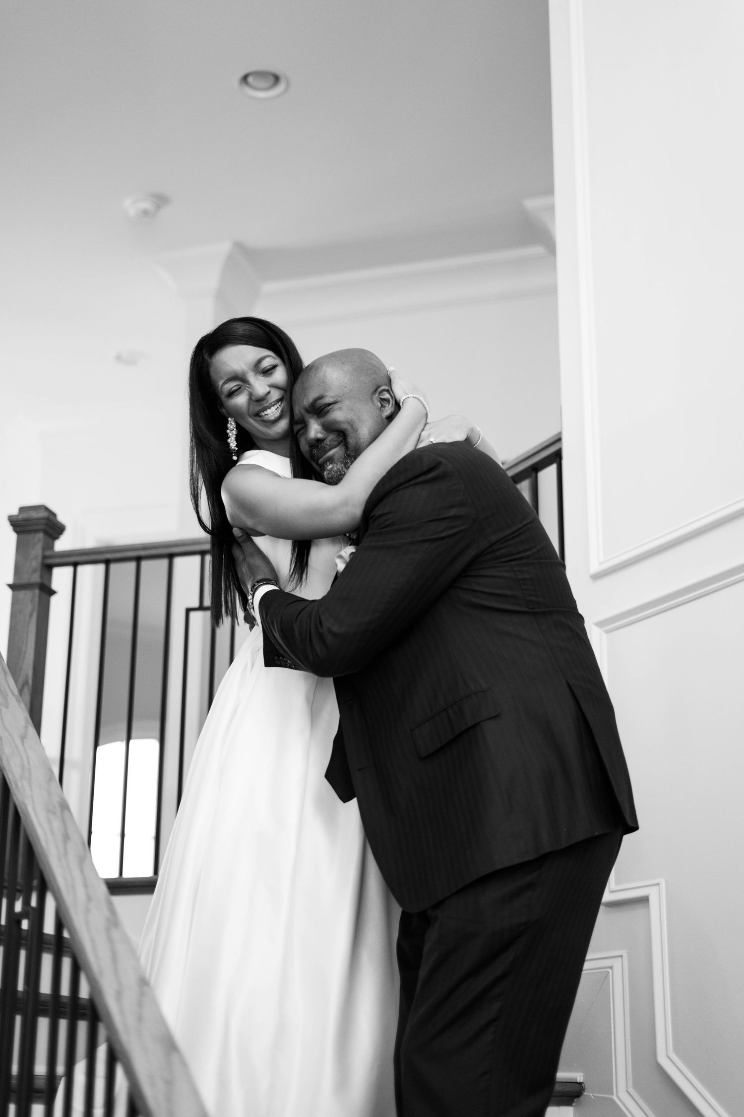 Intimate black and white wedding photos captured on an elegant staircase.