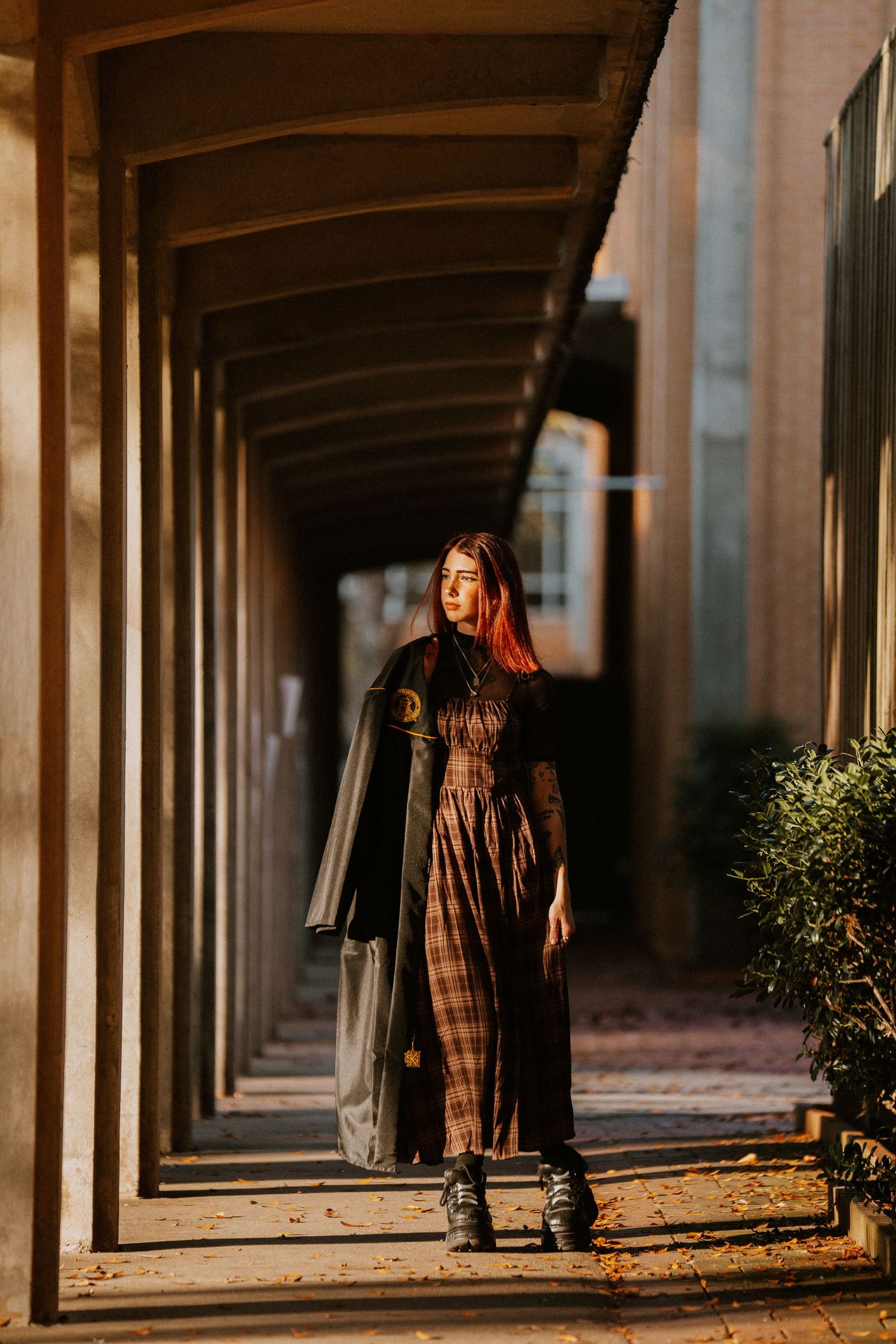 Colonnade walkway with repeating architectural columns creating dramatic shadows and perspective.
