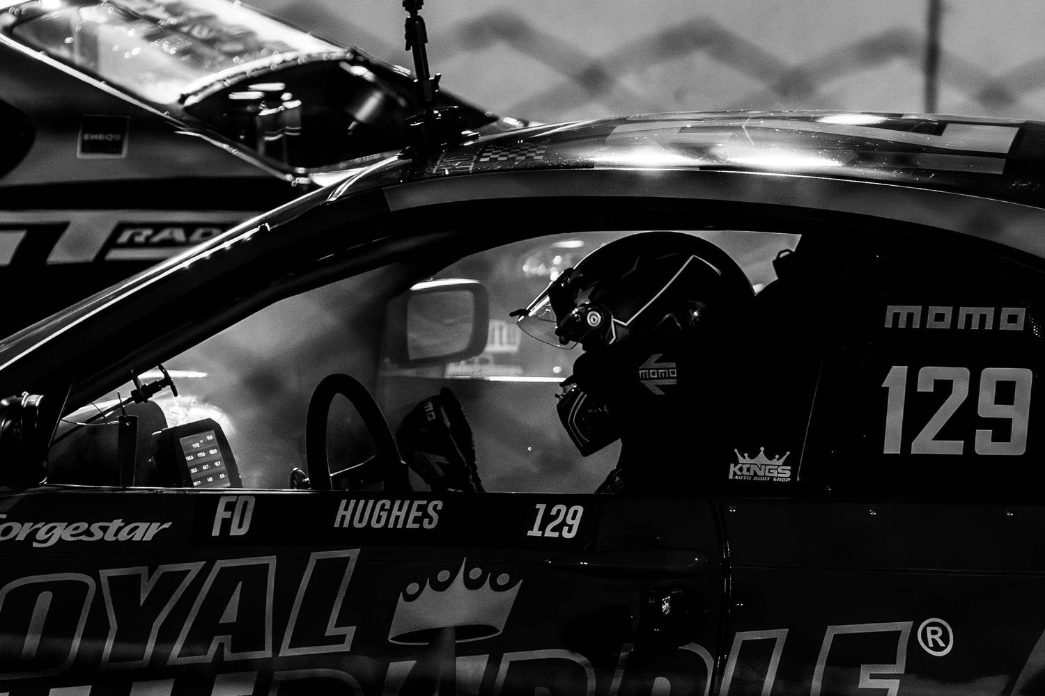Close-up detail of race car interior showing driver controls and safety equipment.