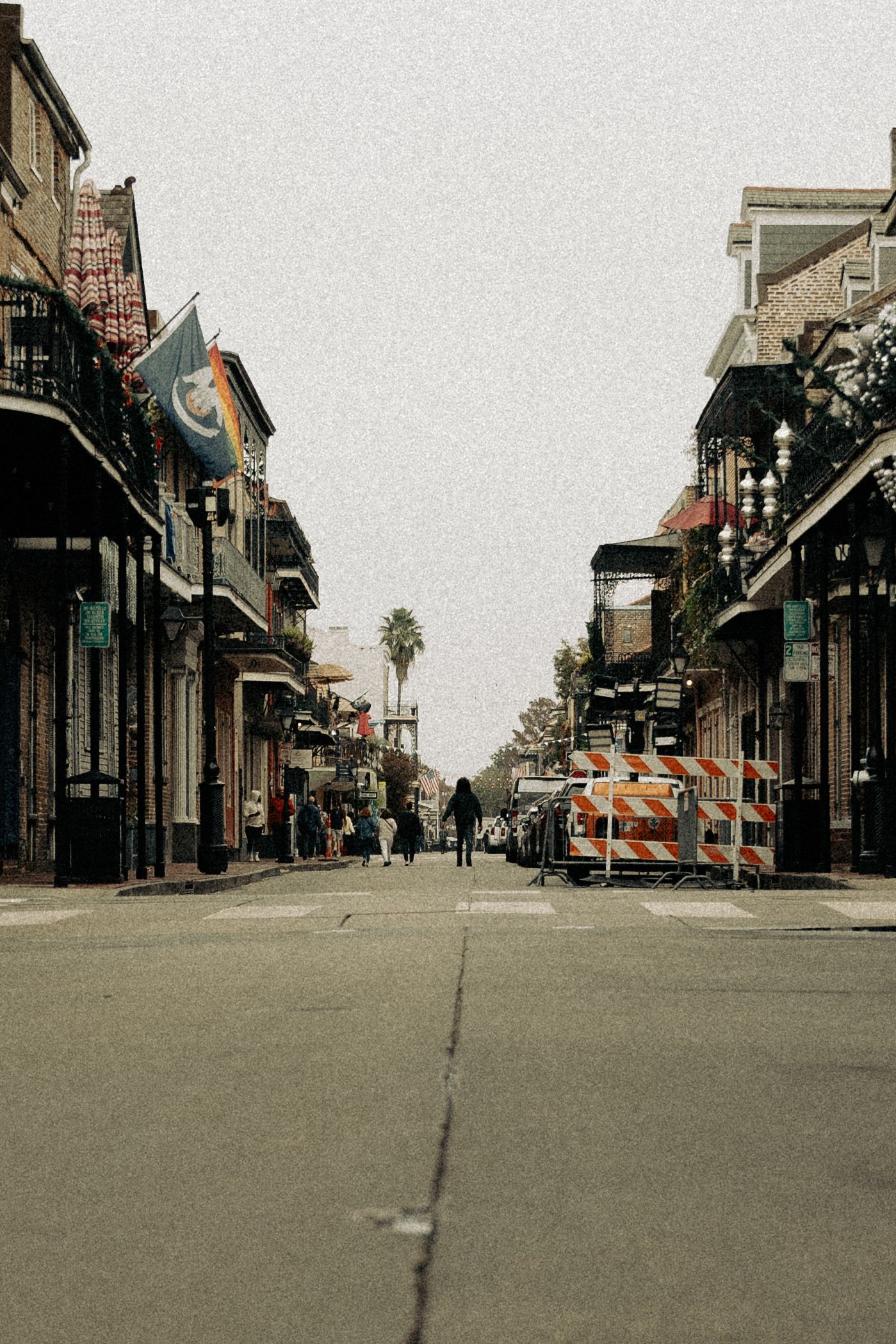 Empty urban street view with historic buildings and storefronts in muted tones.