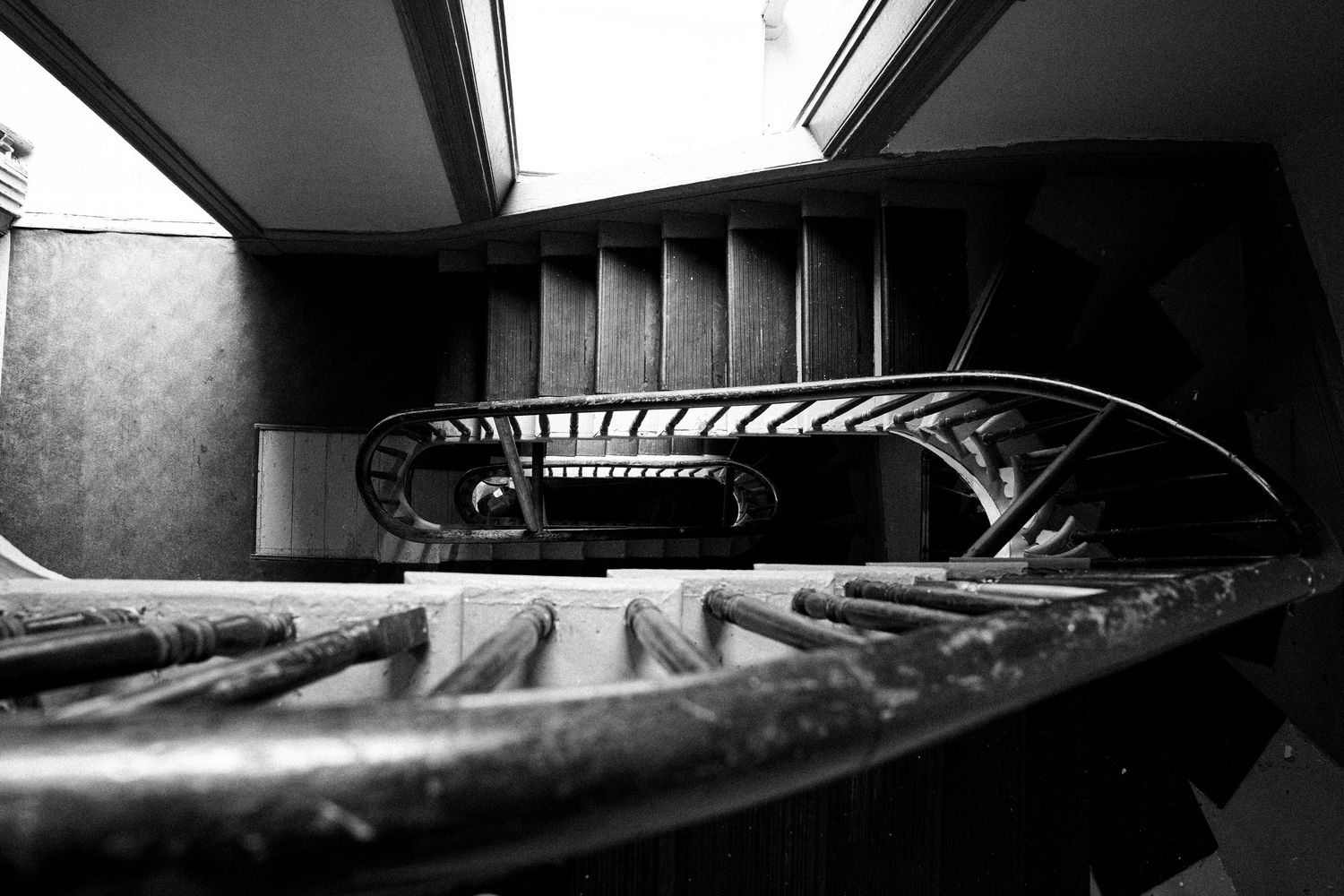 Minimalist black and white architectural interior with dramatic shadows and lines.